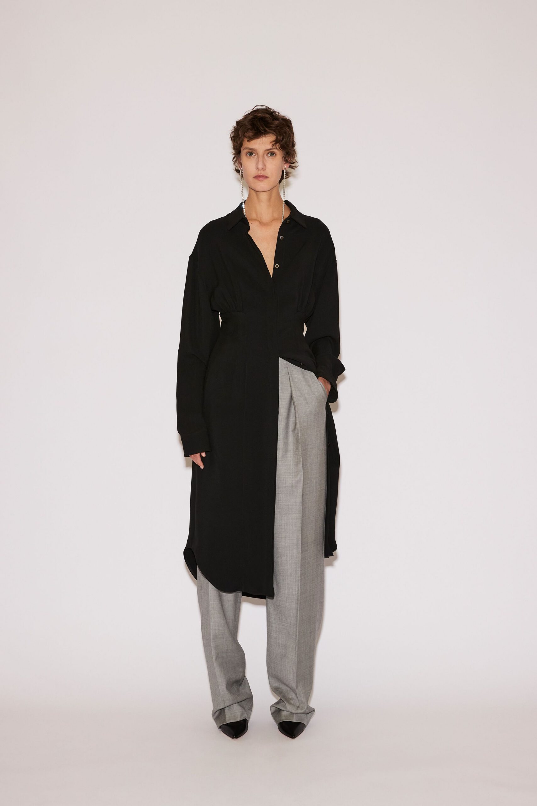 black shirt-dress with gray pants