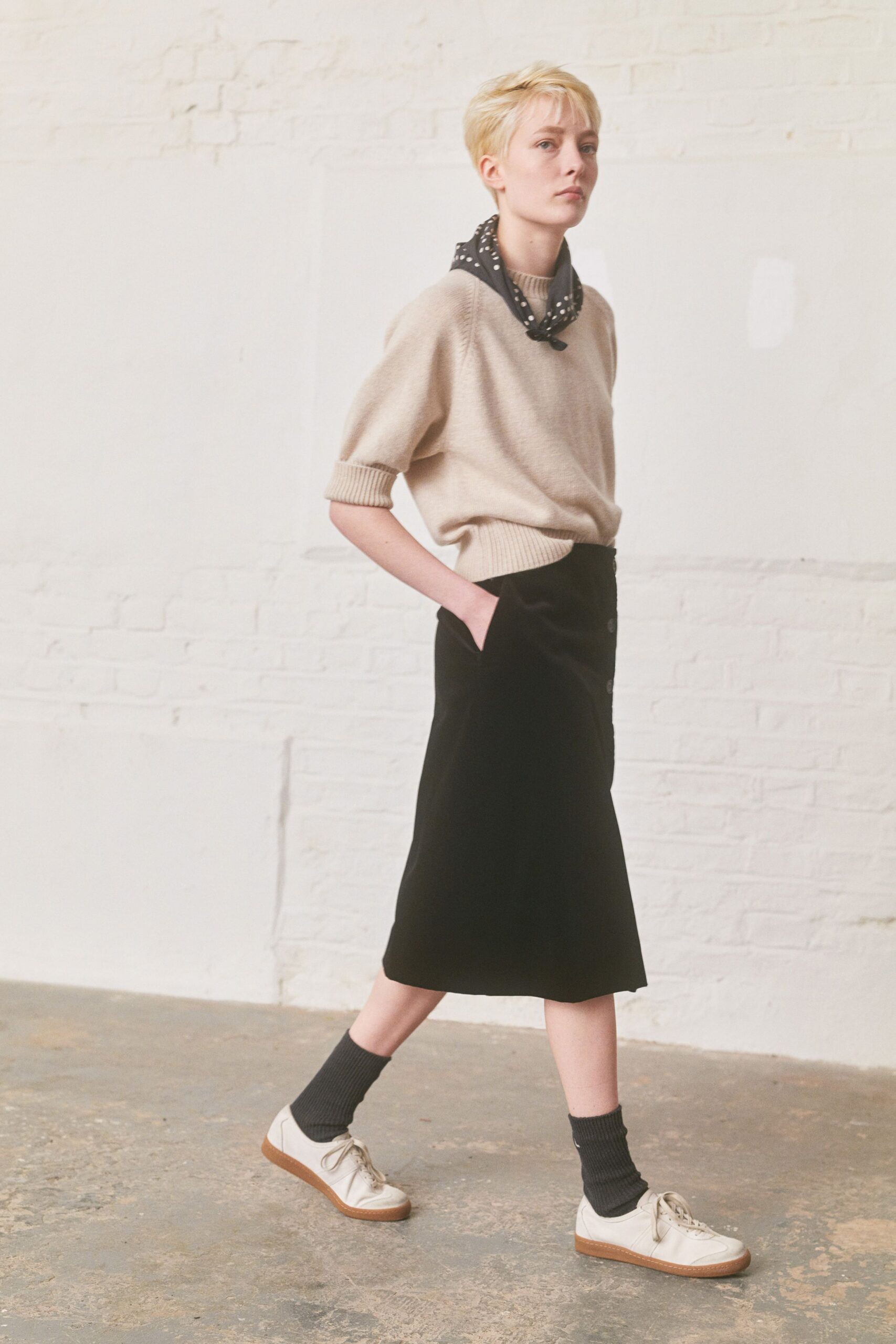 beige relaxed sweater black midi skirt