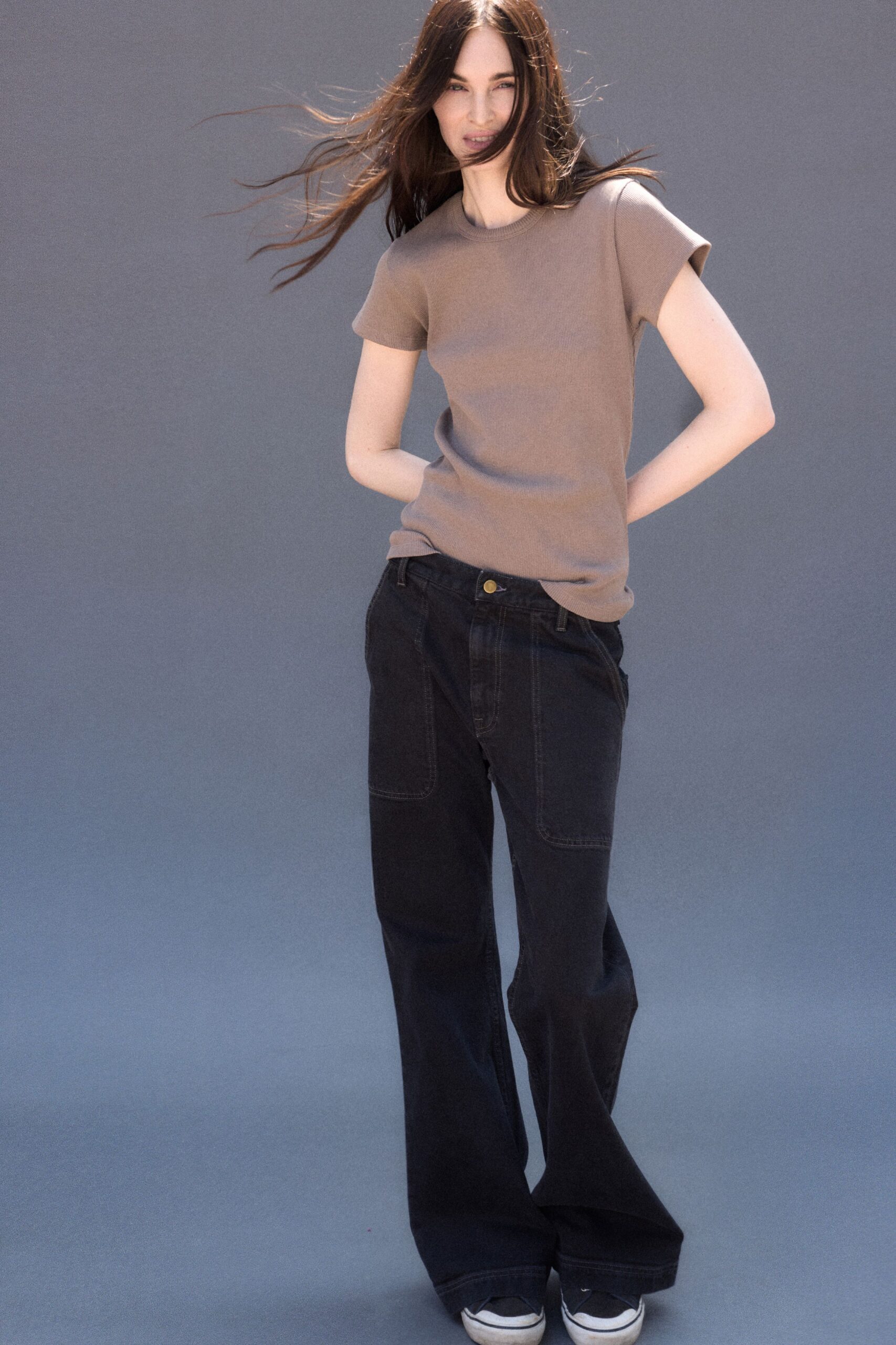 beige t-shirt black wide-leg pants