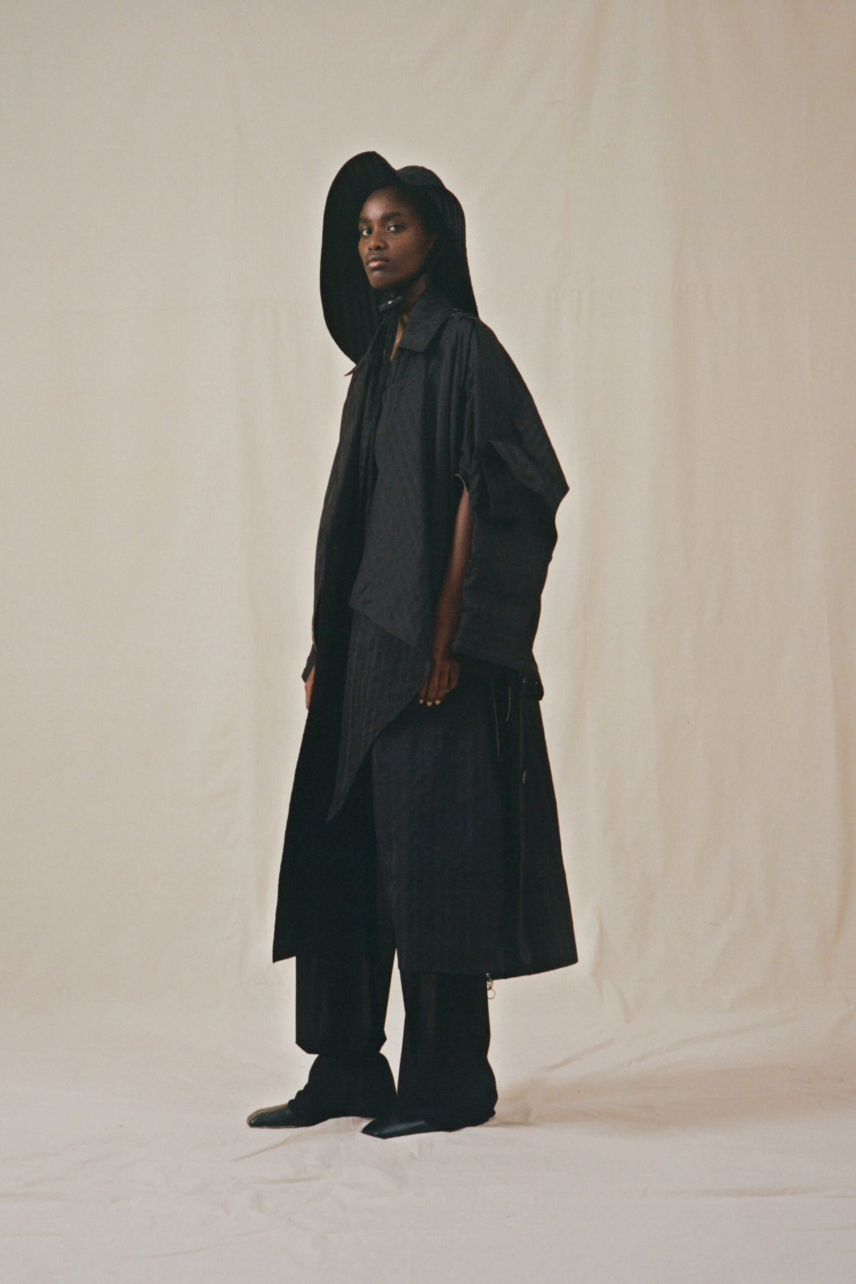 black cape and pants outfit