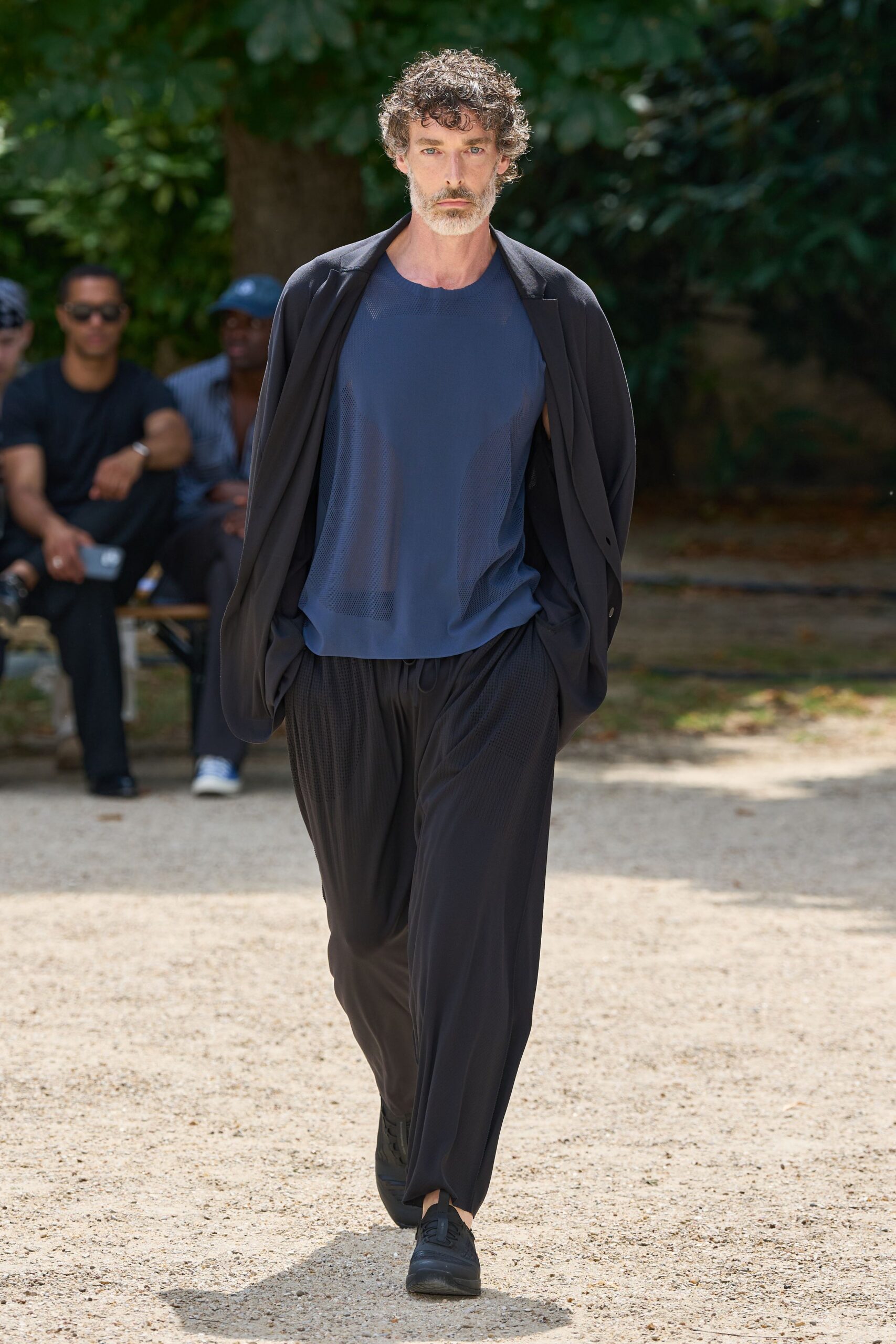 black jacket blue top relaxed pants