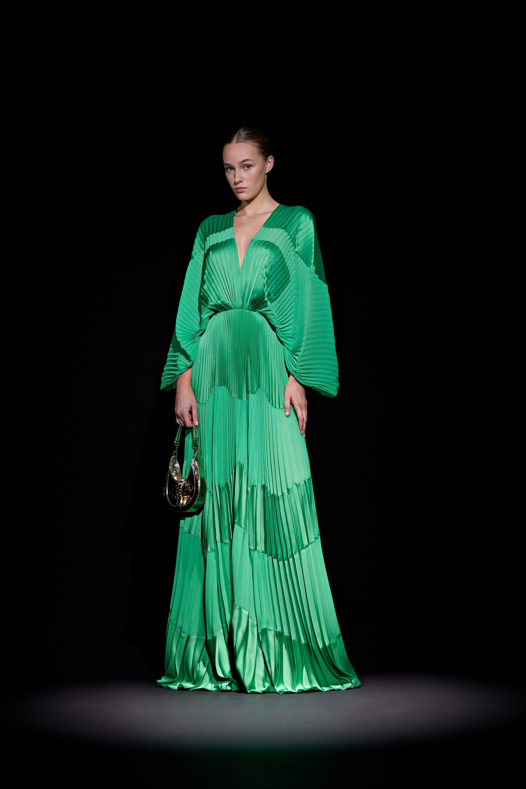 green silk long-sleeve v-neck fitted pleated tiered gown