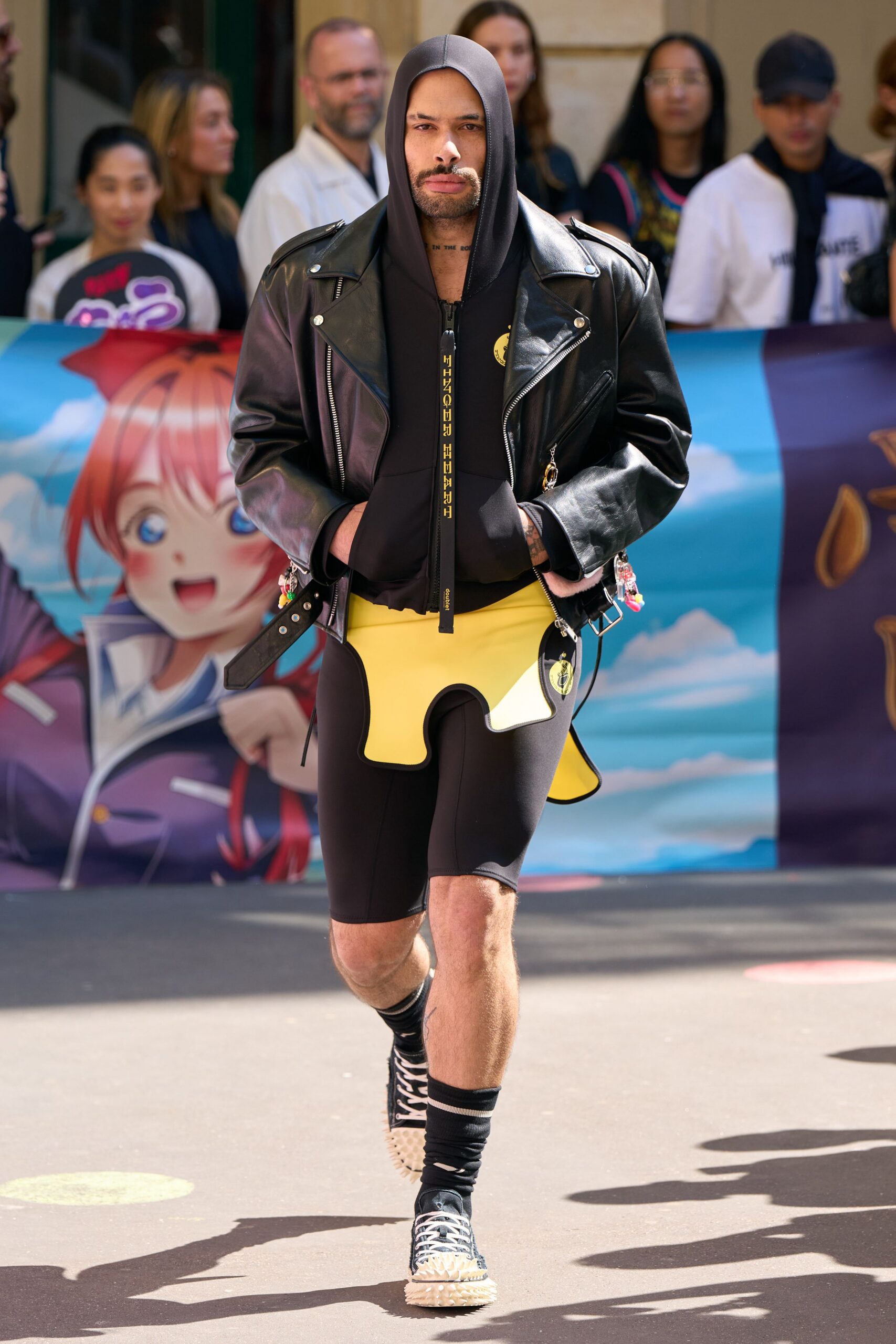 black oversized jacket with bodysuit and yellow shorts