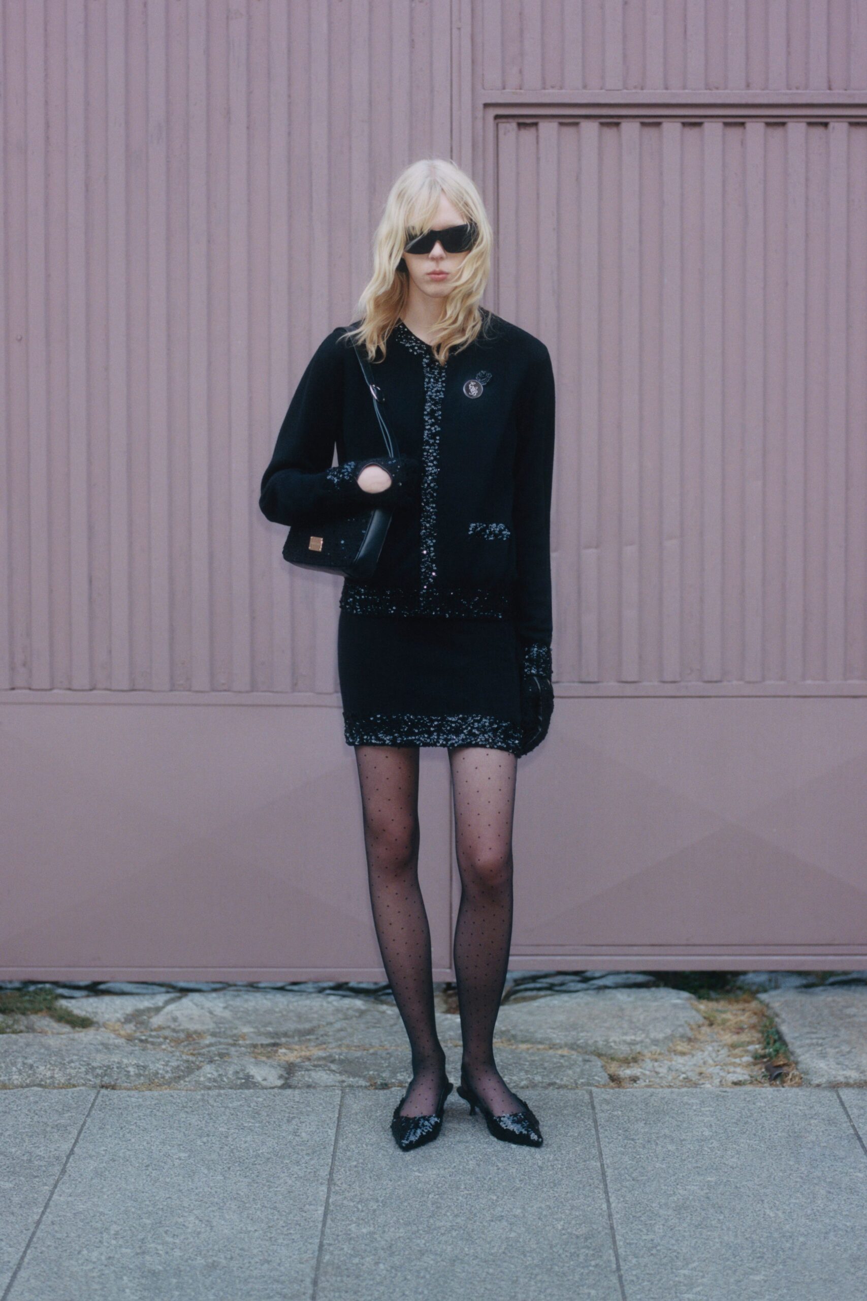 black fitted jacket and mini skirt