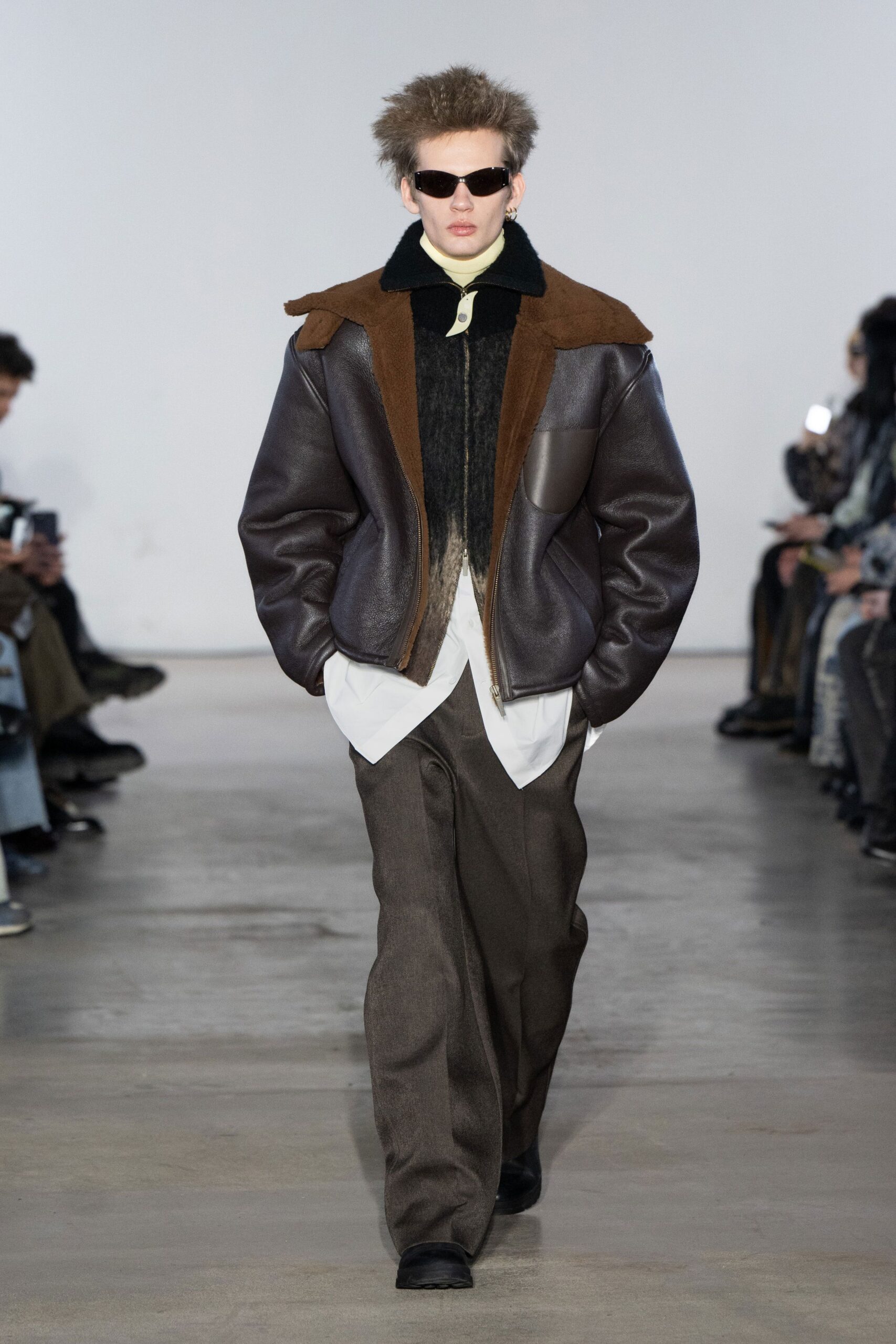 brown leather jacket with gray pants