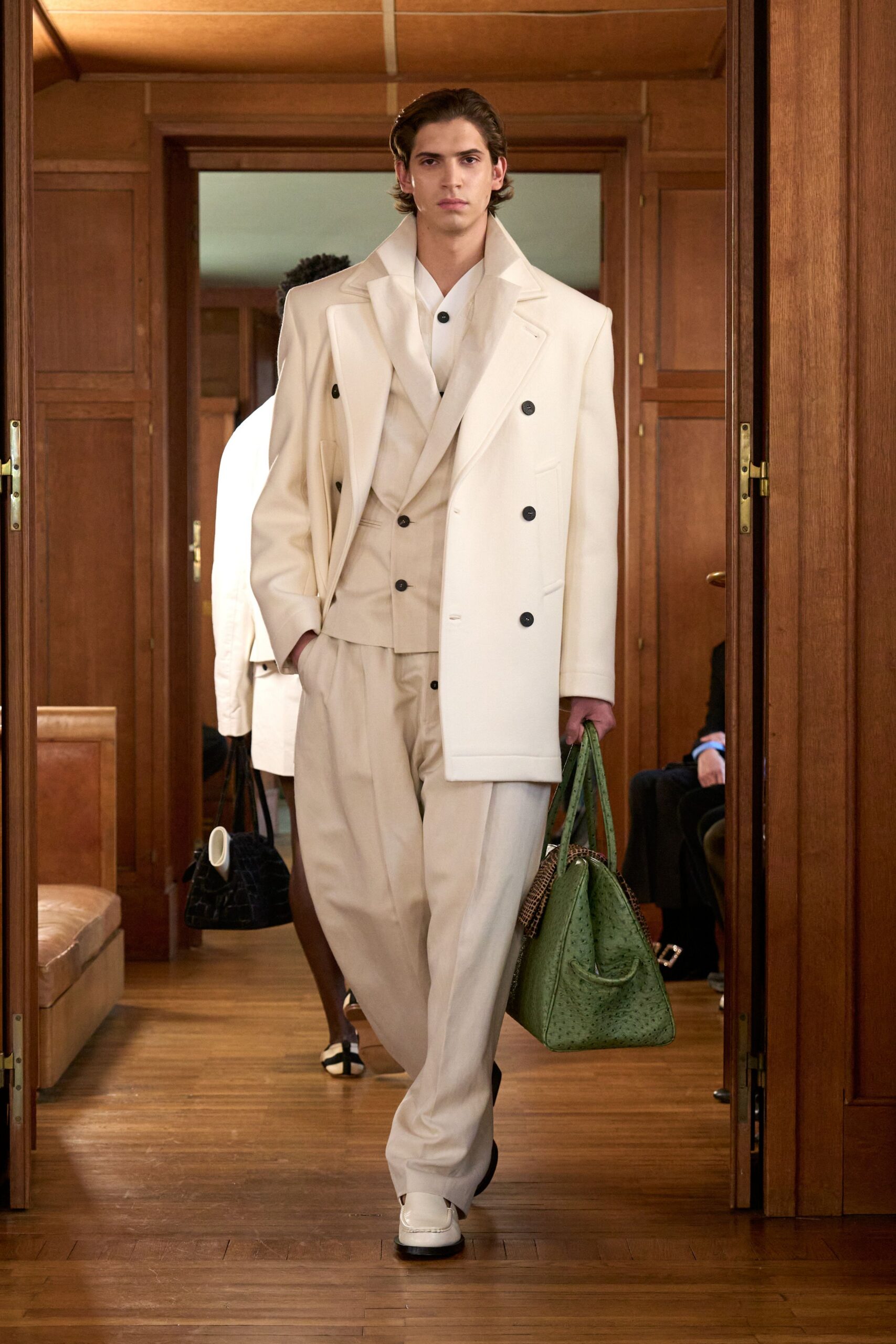 white tailored suit with green bag