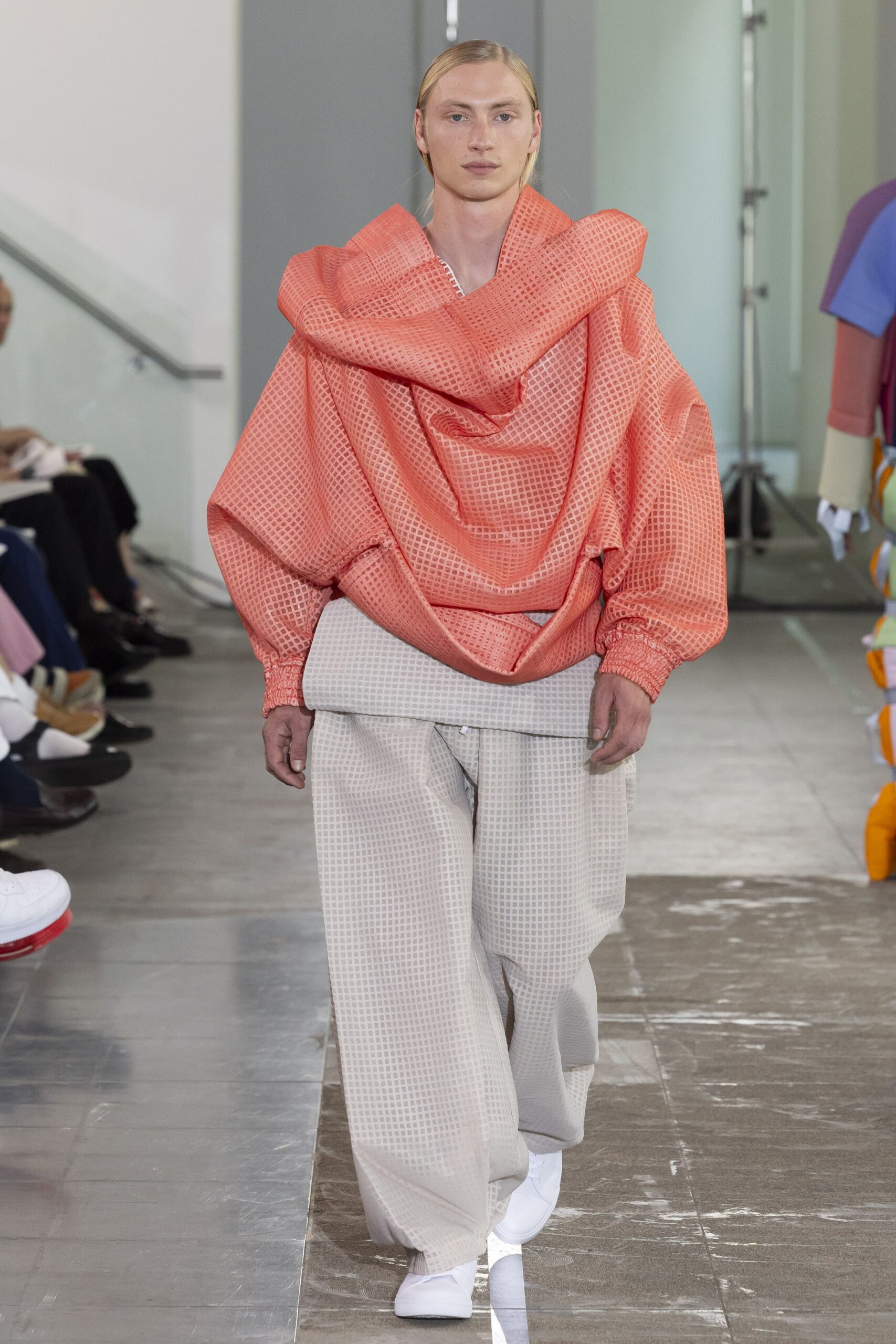 coral relaxed top with beige wide-leg pants