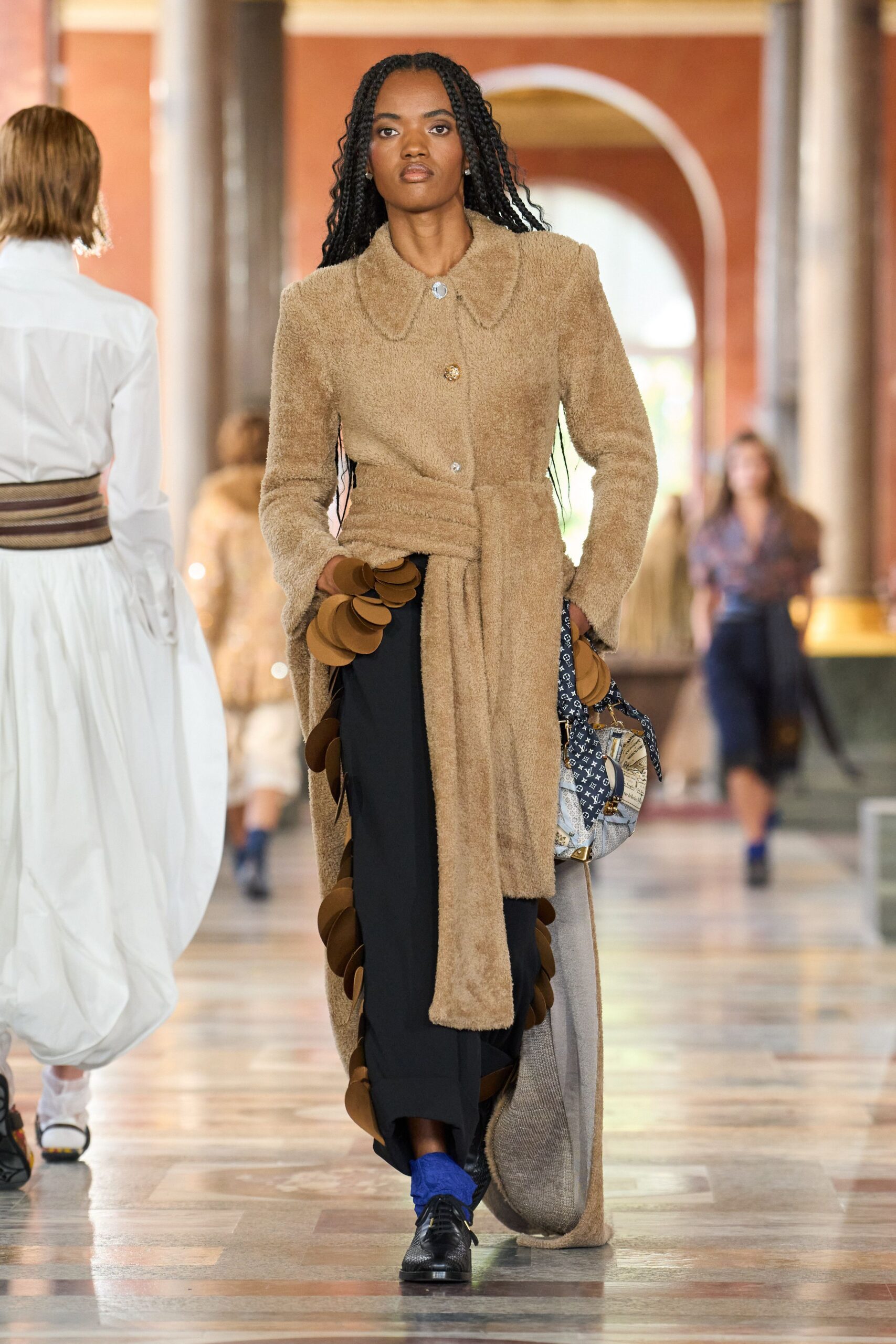 beige faux-fur coat with black pants