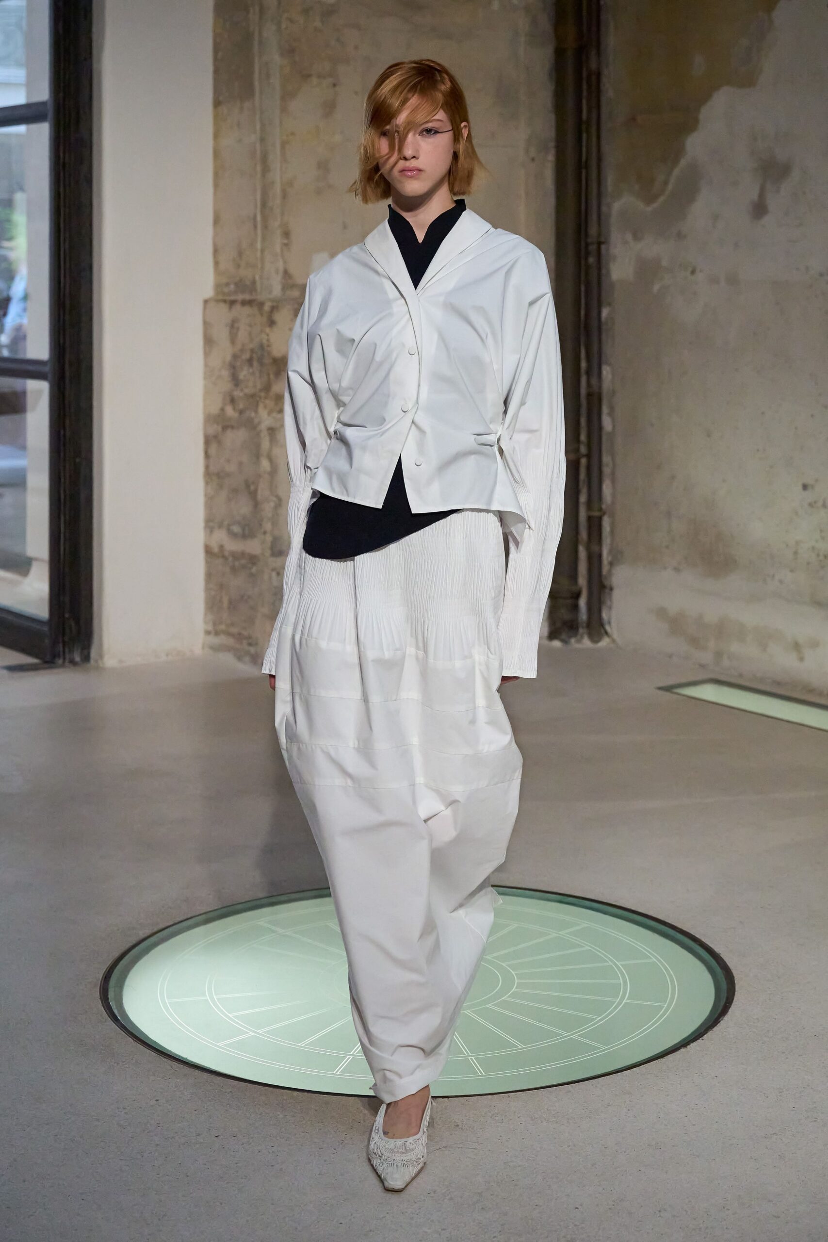 white jacket black top pleated skirt