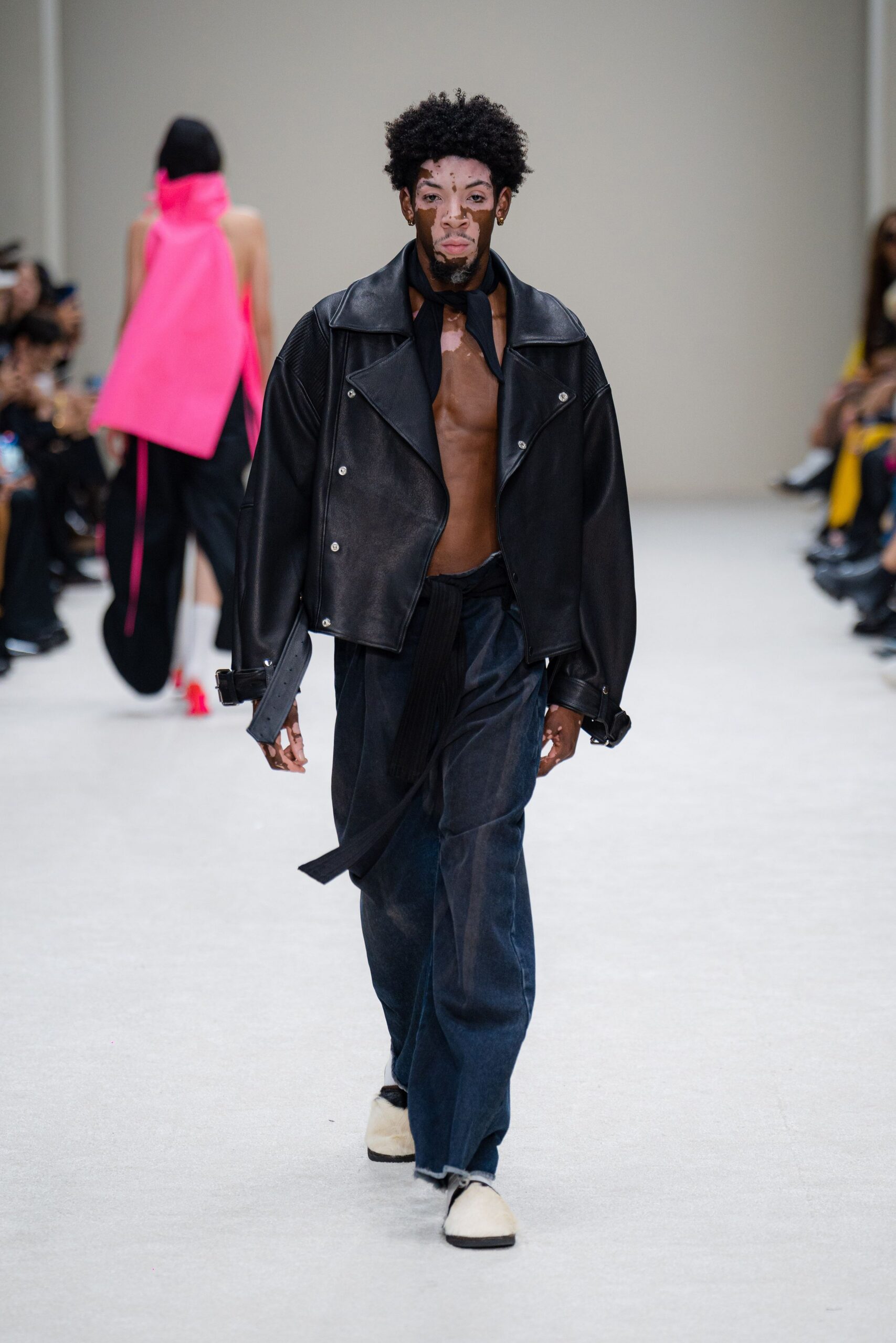 black leather jacket with blue denim pants