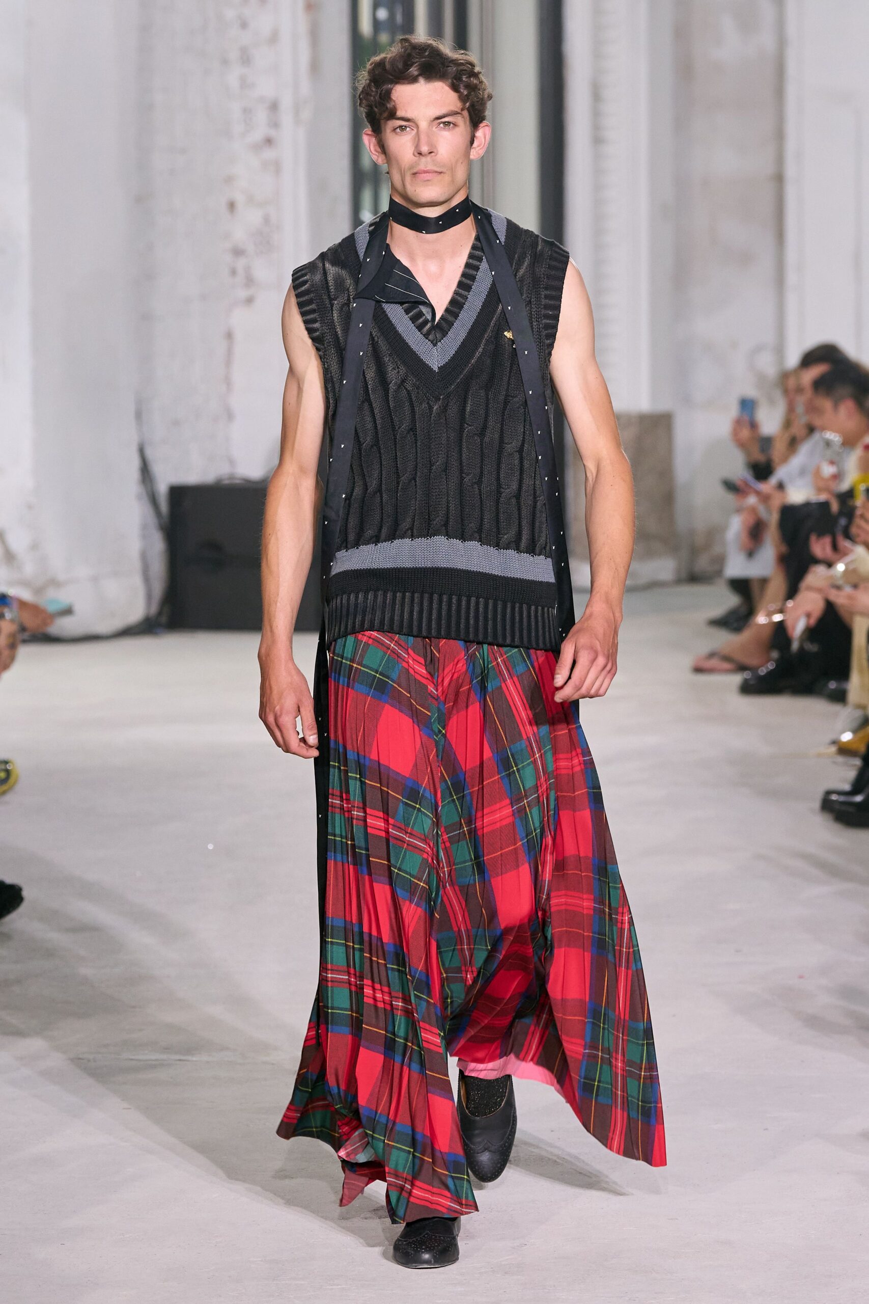 black sleeveless top with plaid skirt
