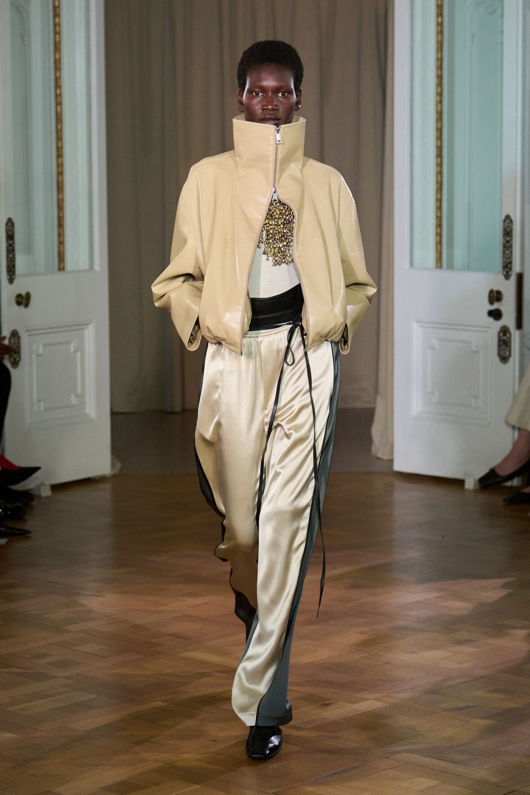 beige vinyl long-sleeve collared oversized zippered jacket