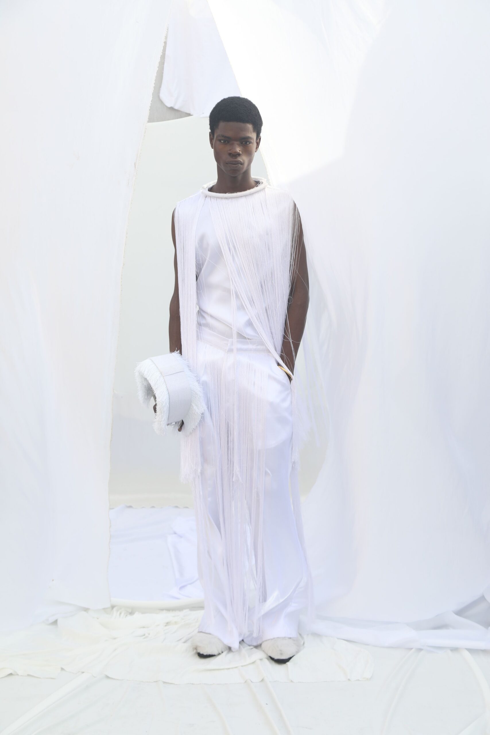 white silk sleeveless high-neck fitted fringed flowing gown