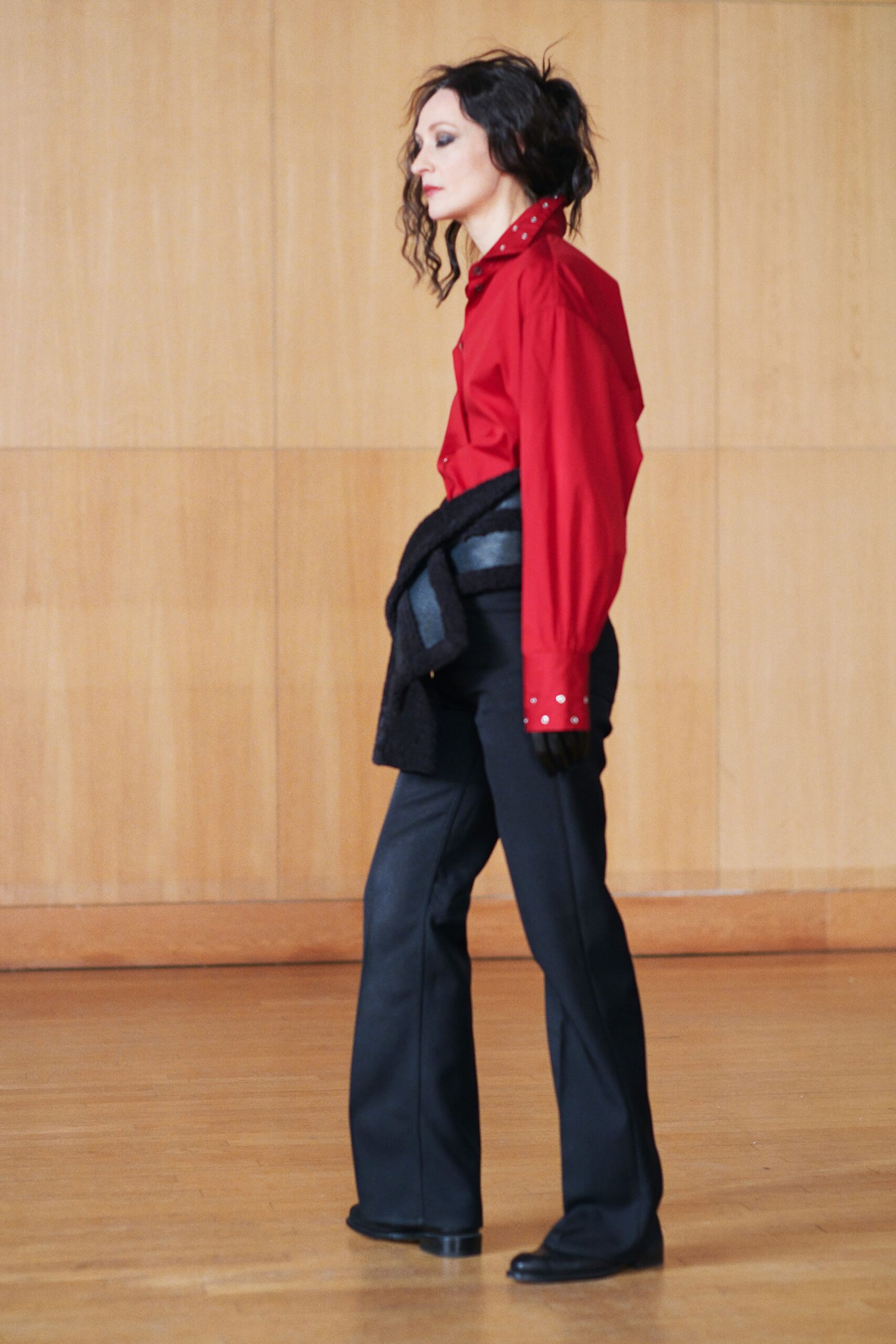 red fitted shirt and black pants