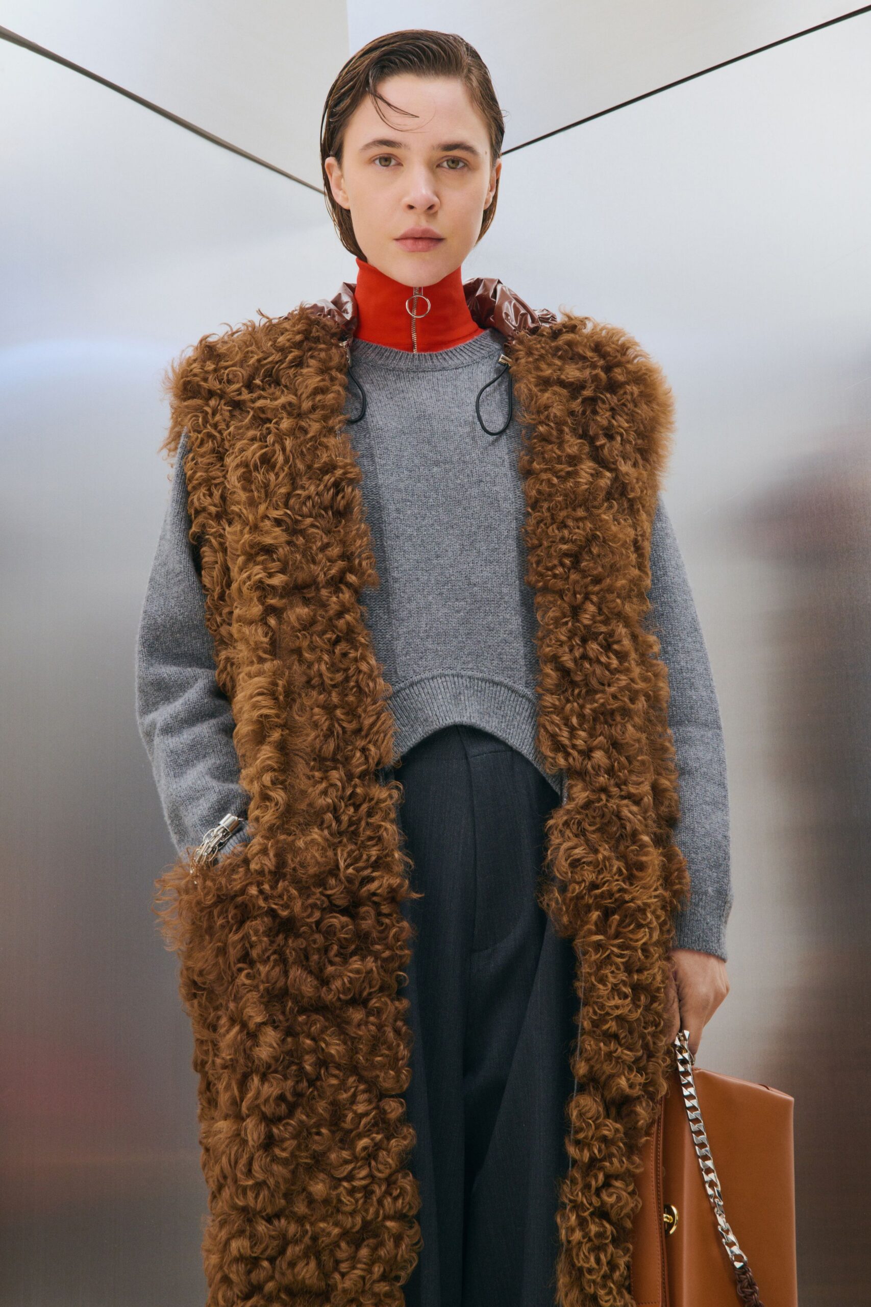 brown fur coat gray sweater black pants