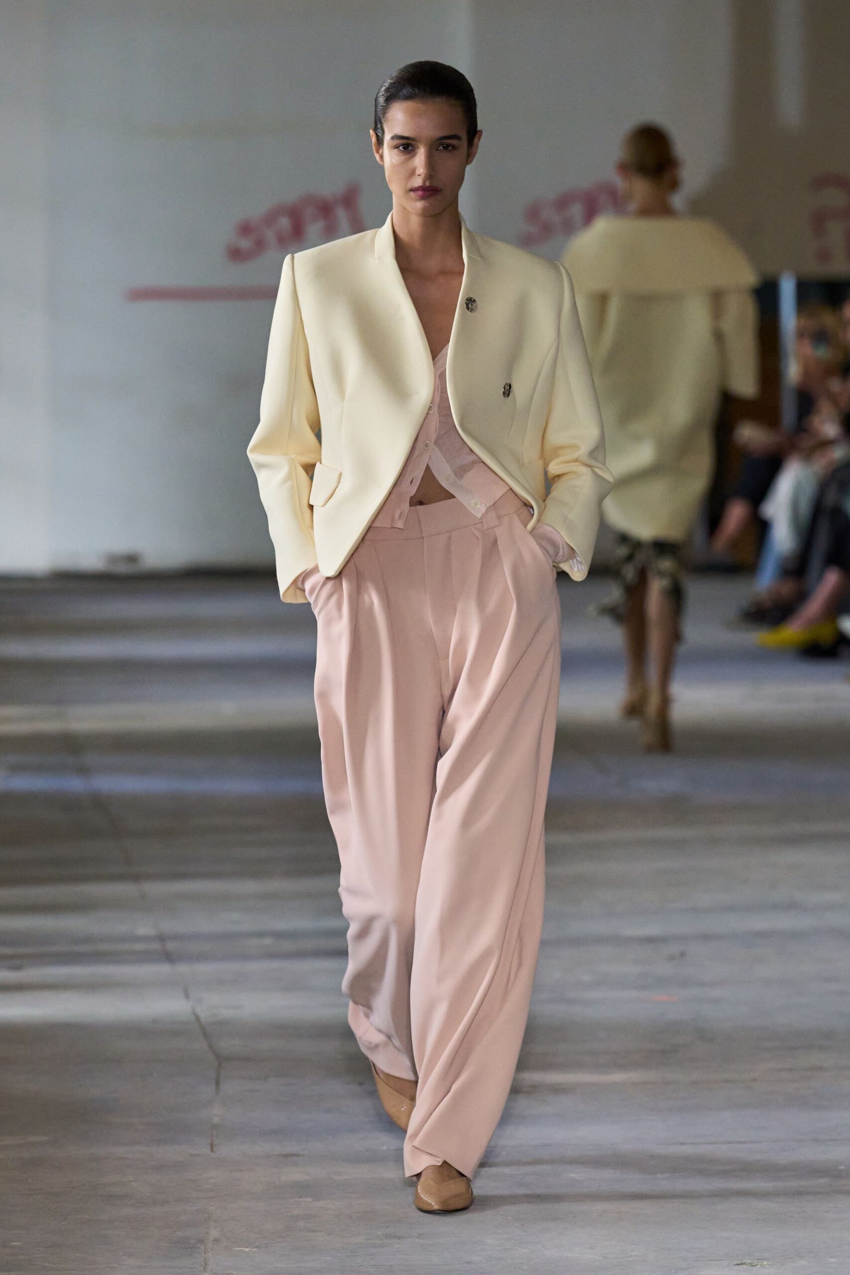 white blazer pink top beige pants