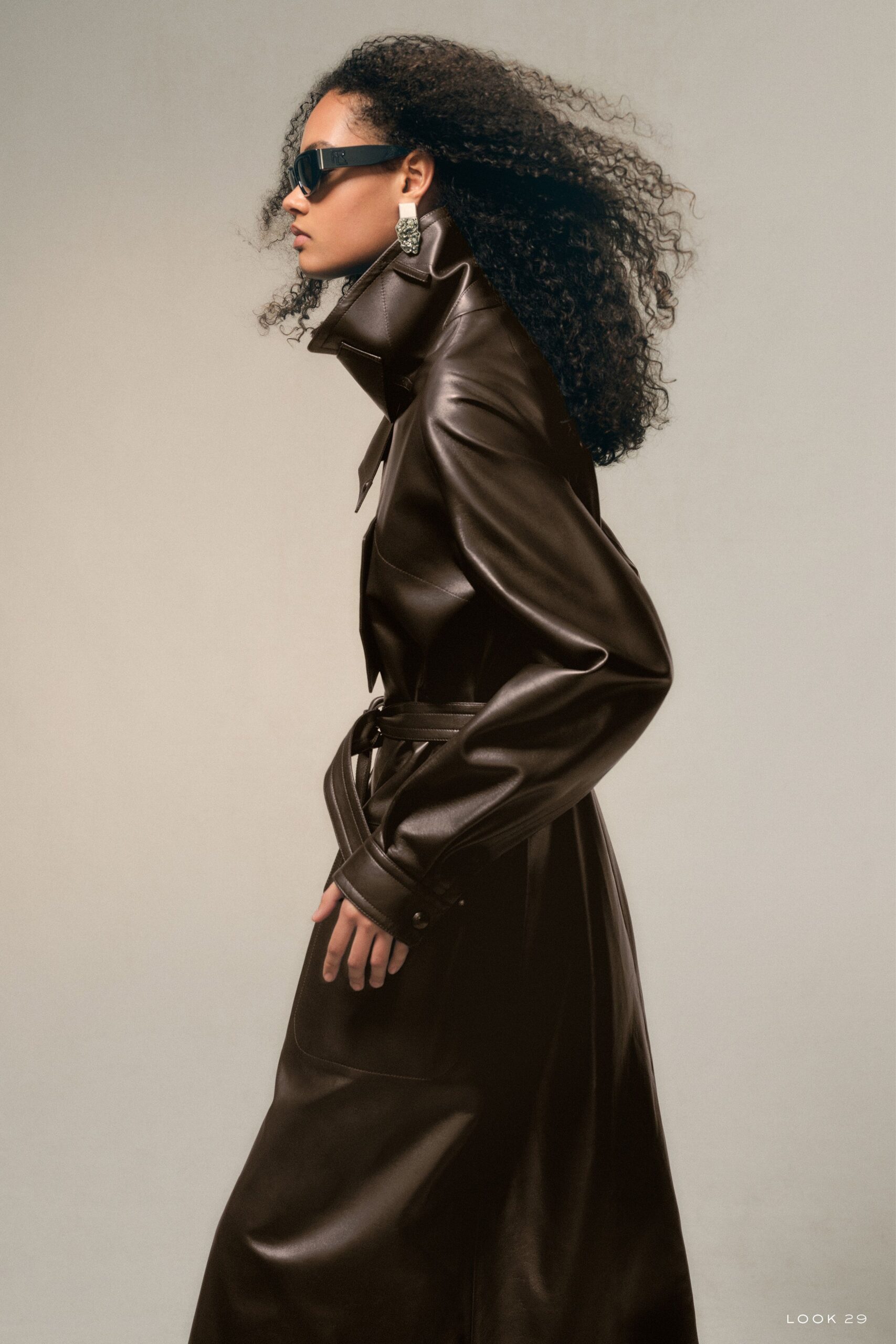 brown leather belted coat with sunglasses