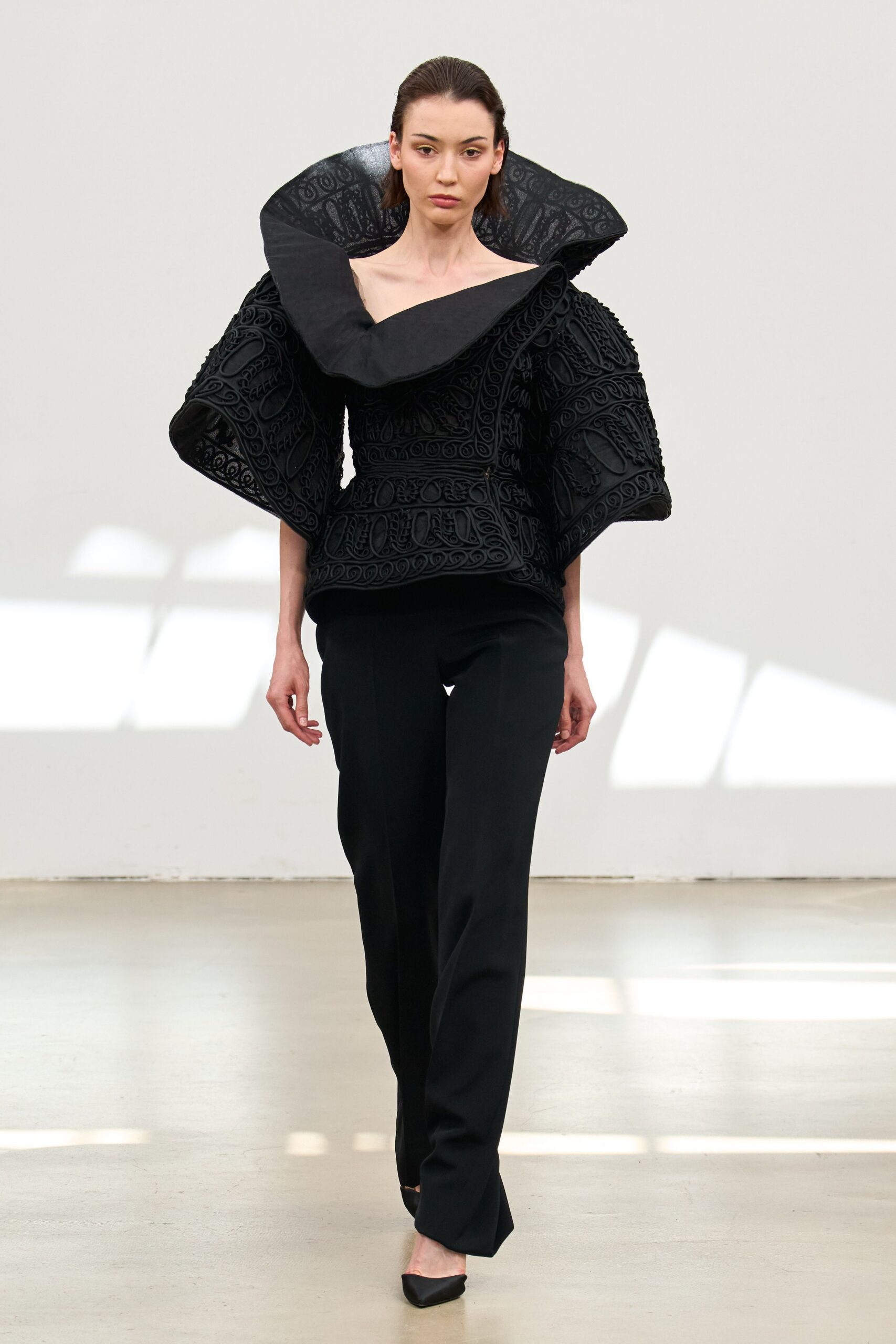 black embroidered top with tailored pants