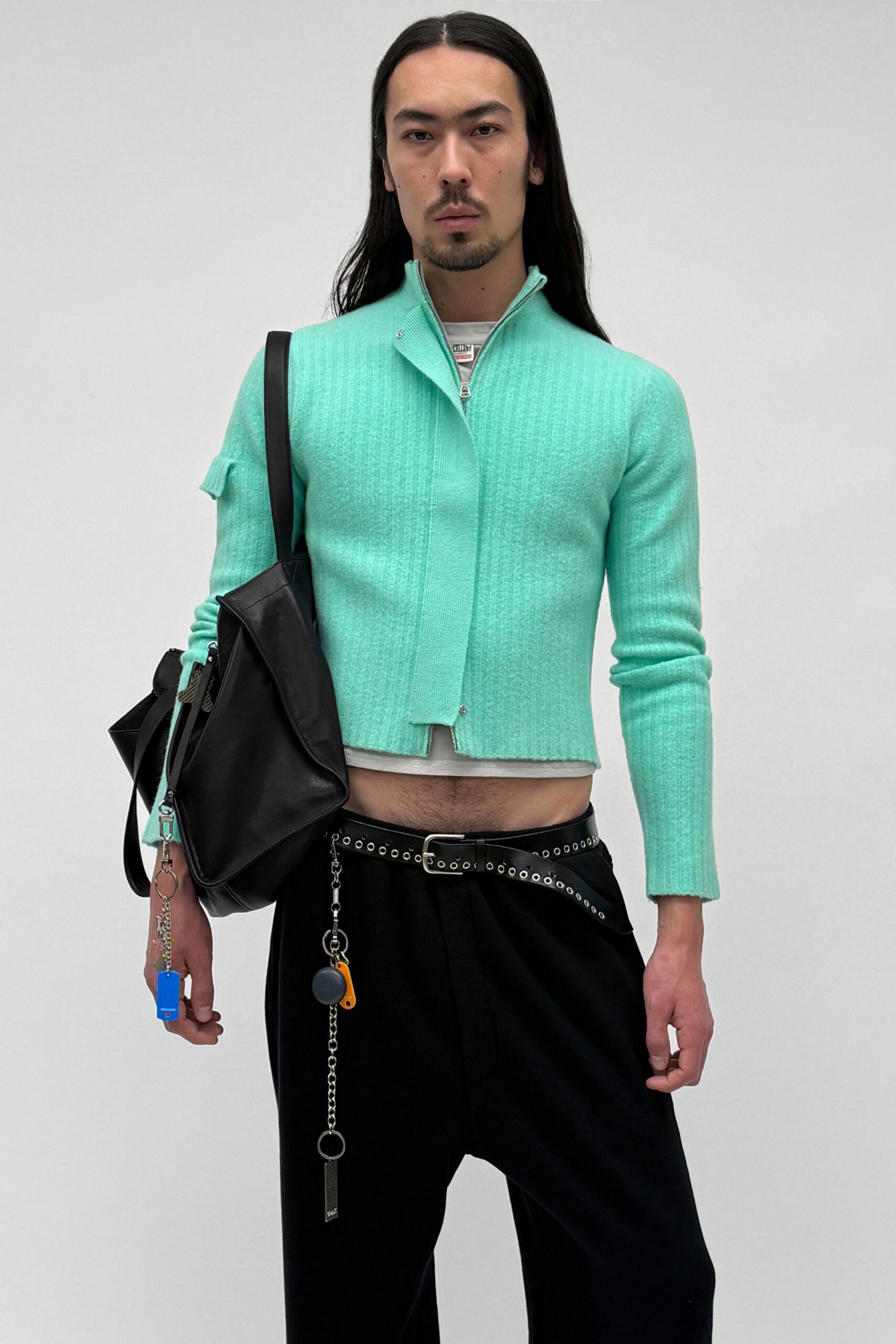 teal fitted jacket with black pants