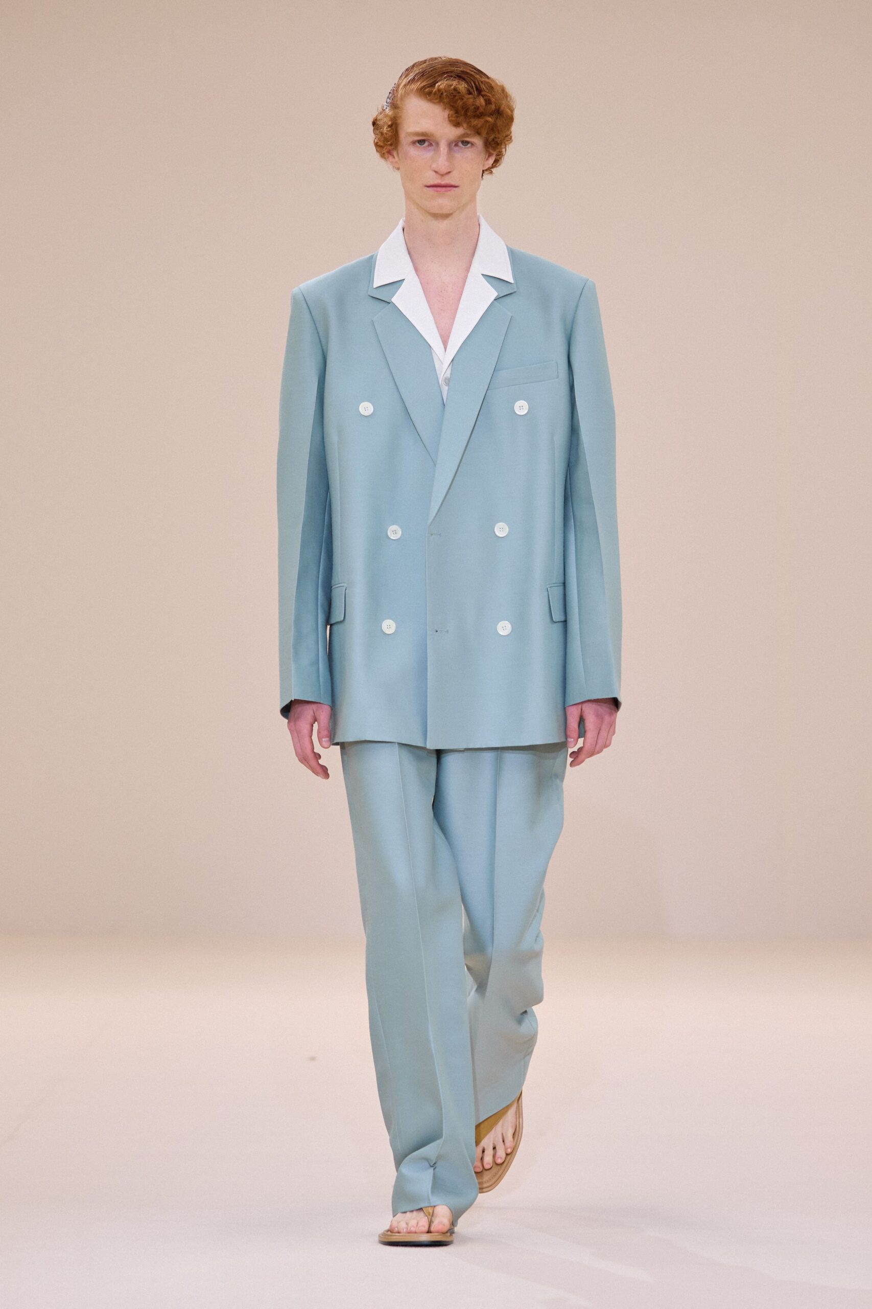 blue tailored suit with beige shoes