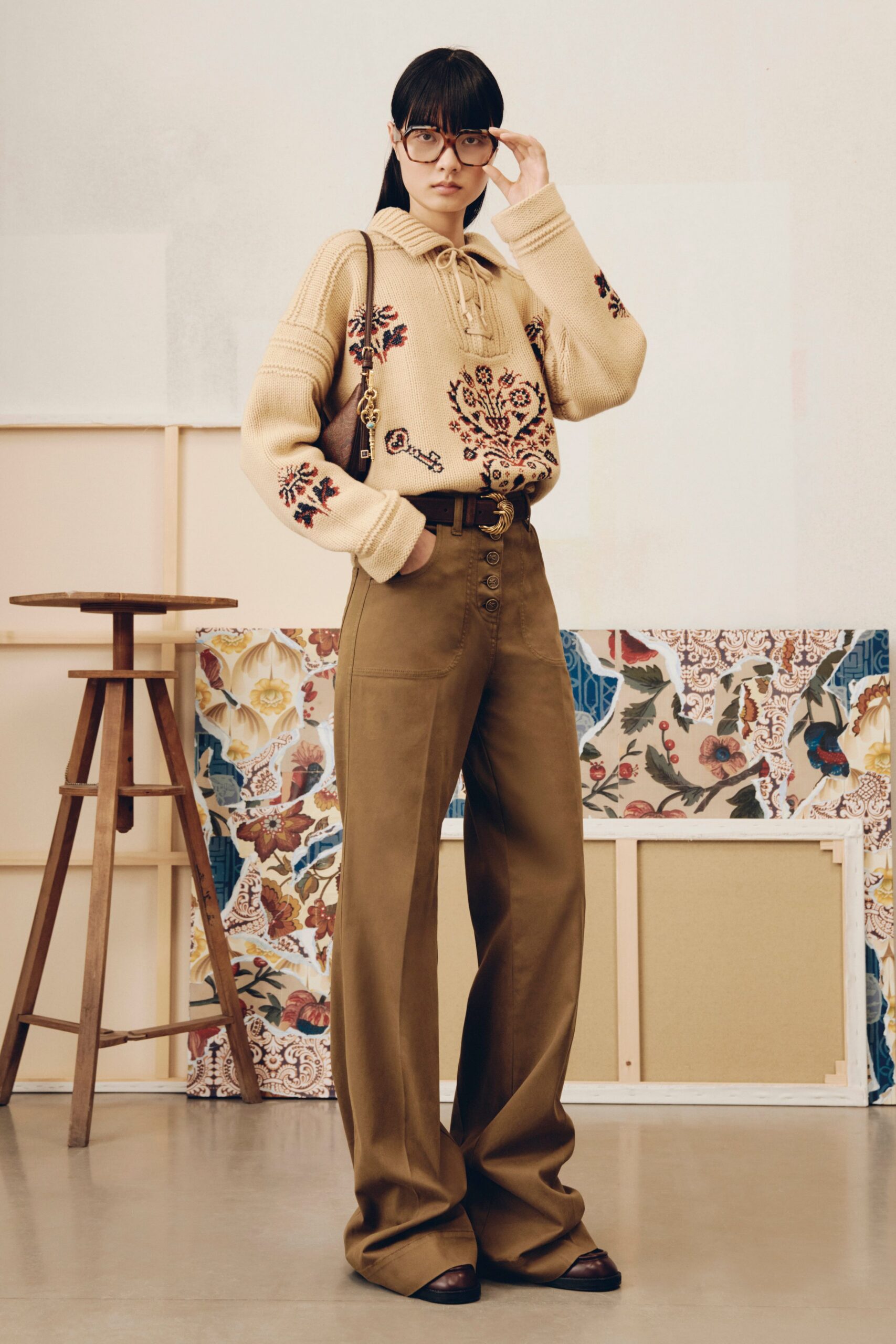 beige embroidered sweater and brown pants