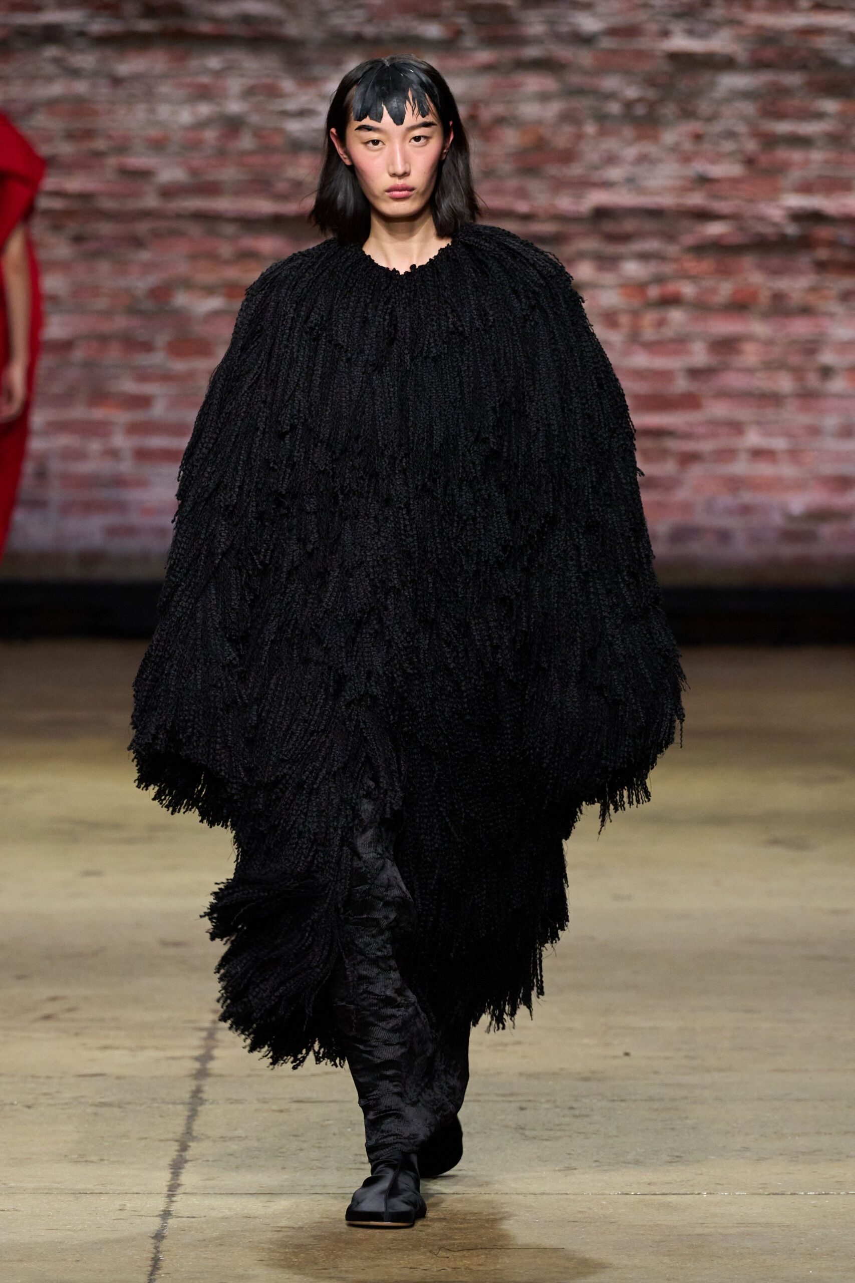 black fringed cape with fitted pants