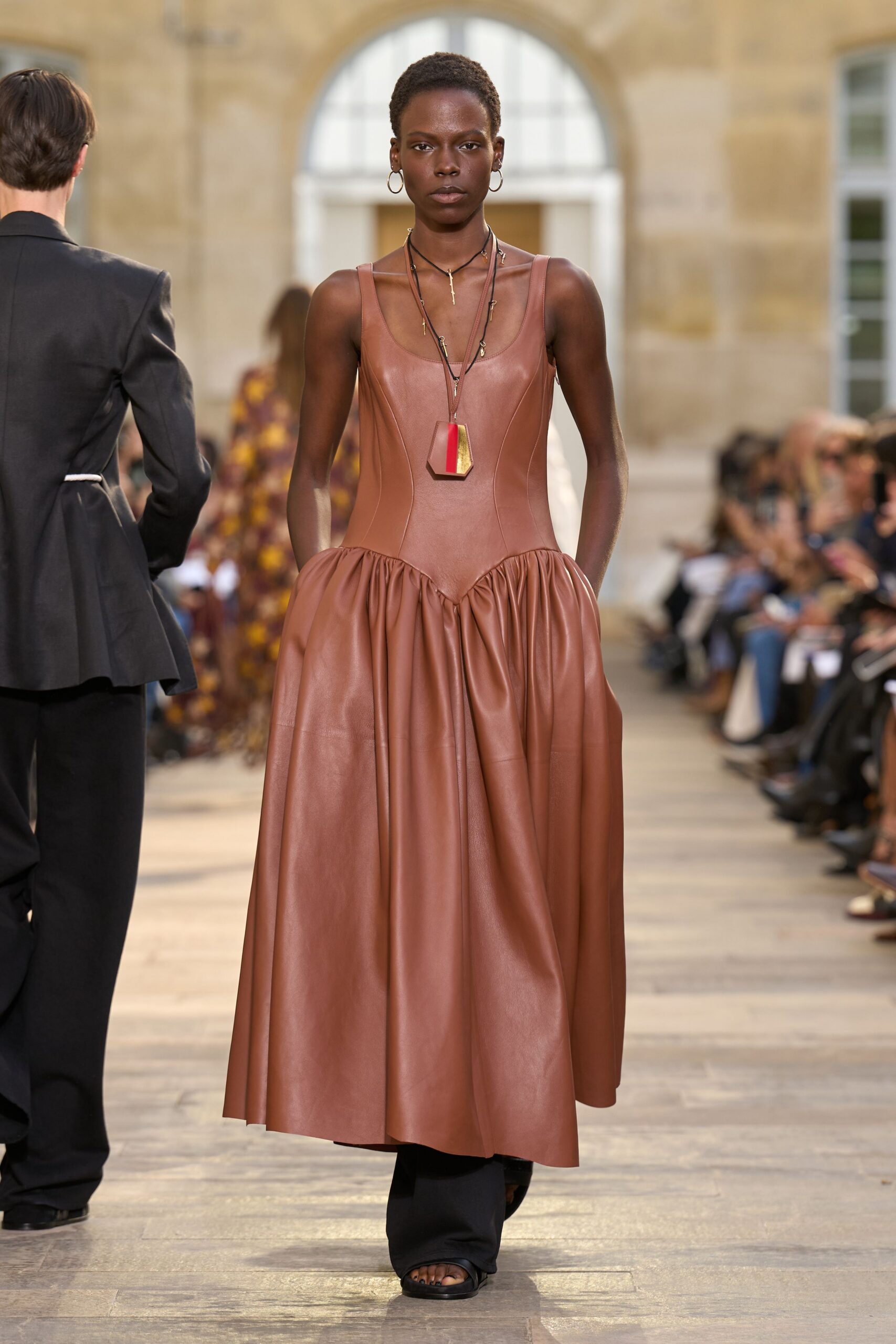 brown leather sleeveless dress with black pants