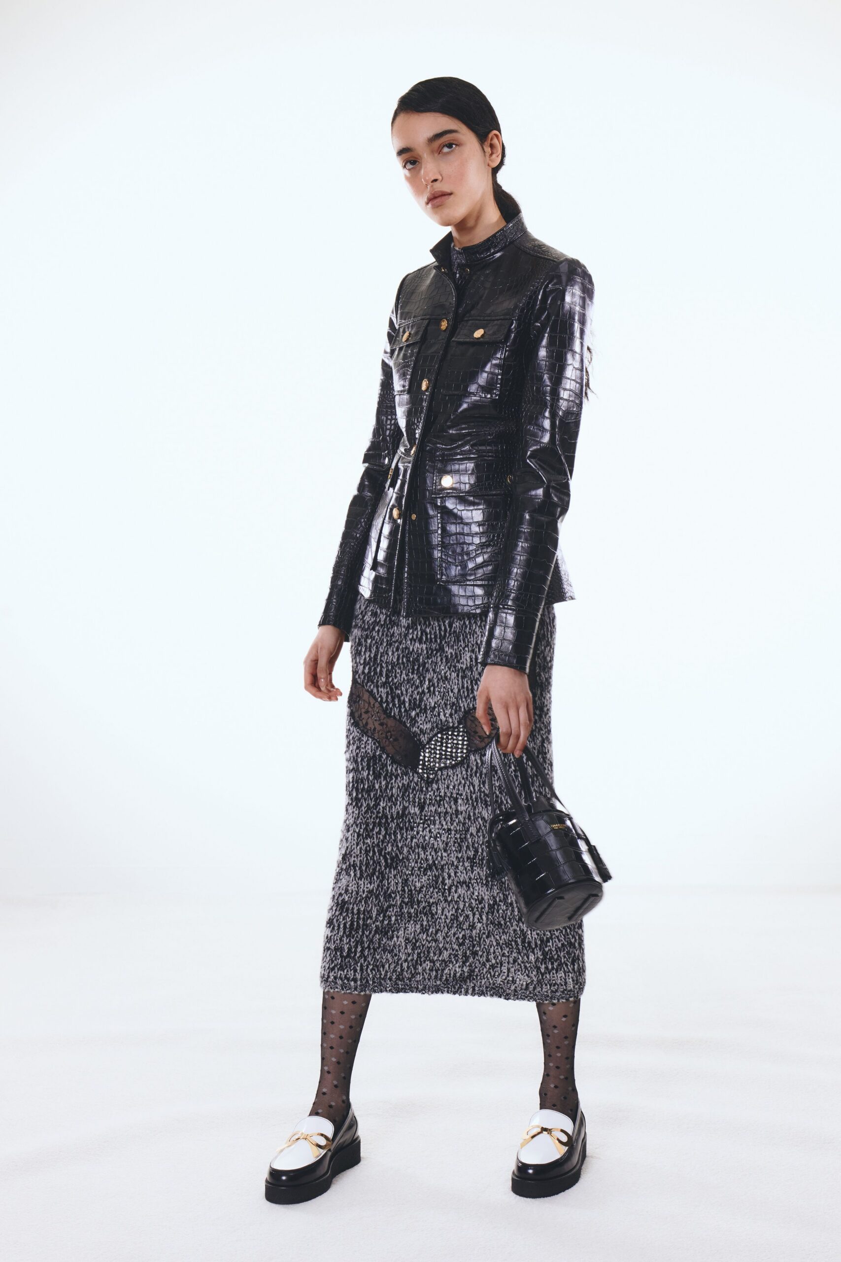 black leather jacket with gray skirt
