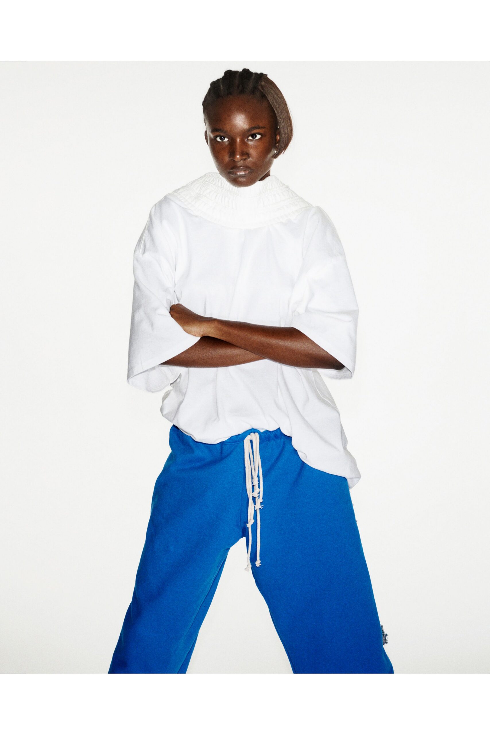 white relaxed top with blue pants