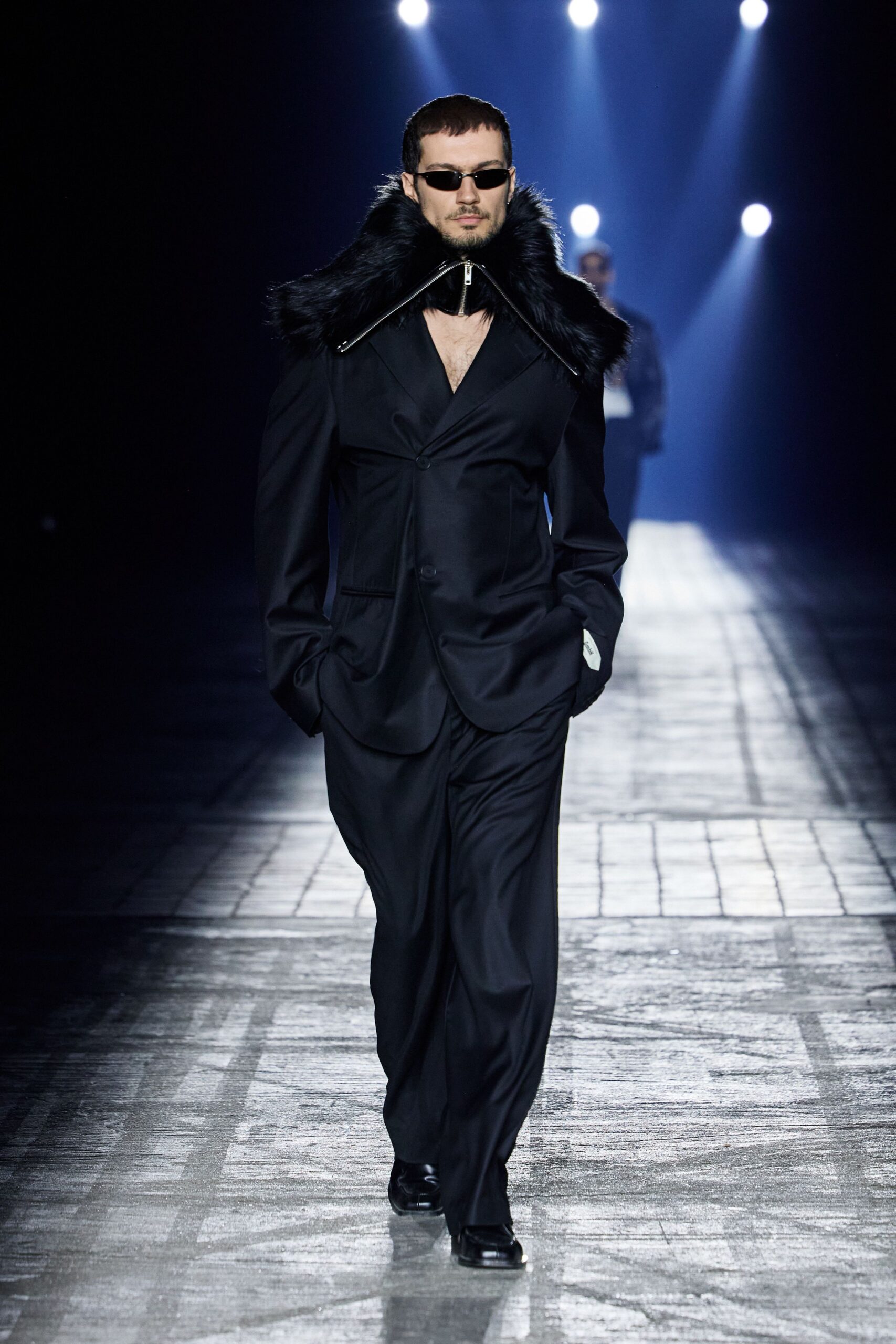 black tailored suit with fur cape