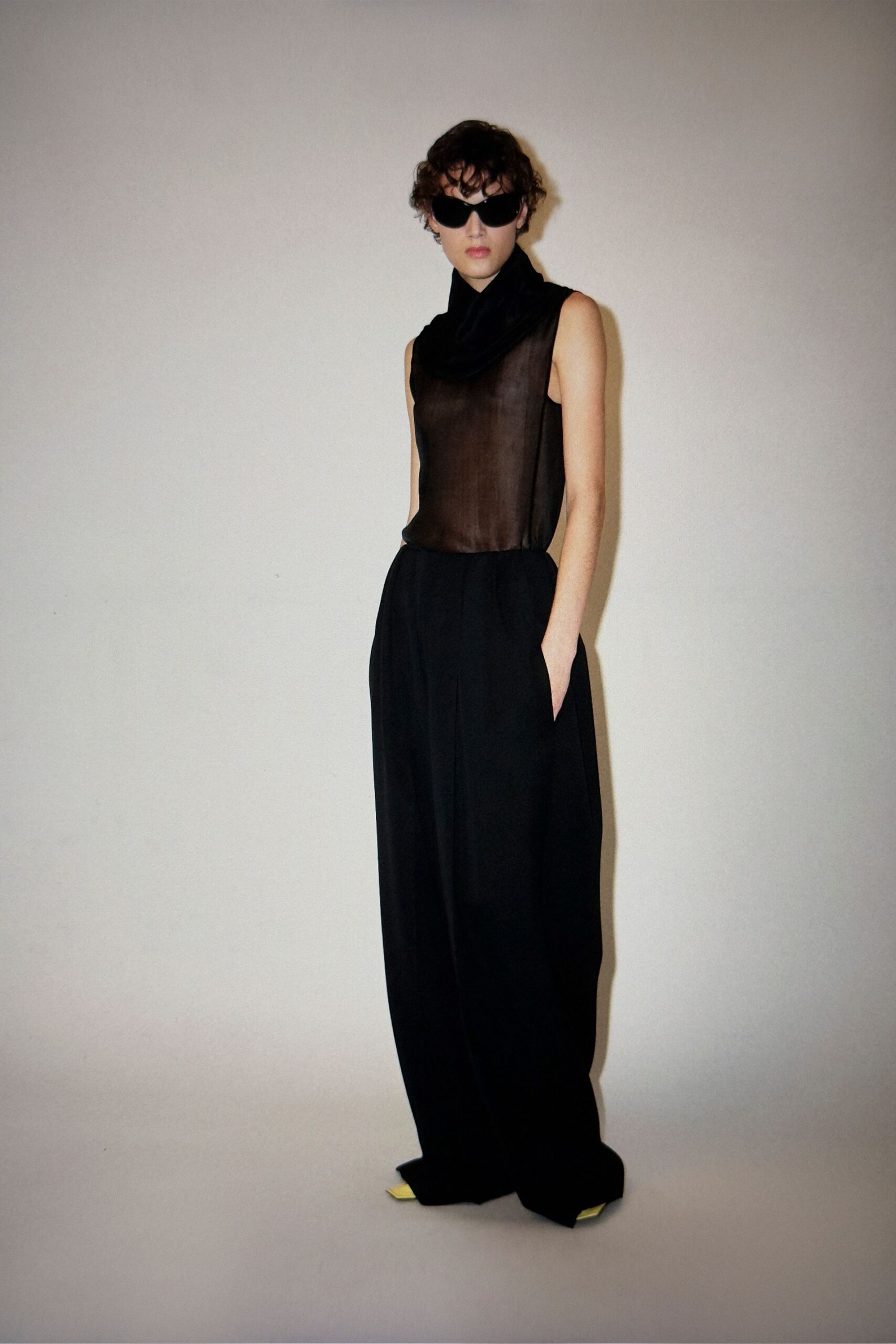 black sheer top and wide-leg pants