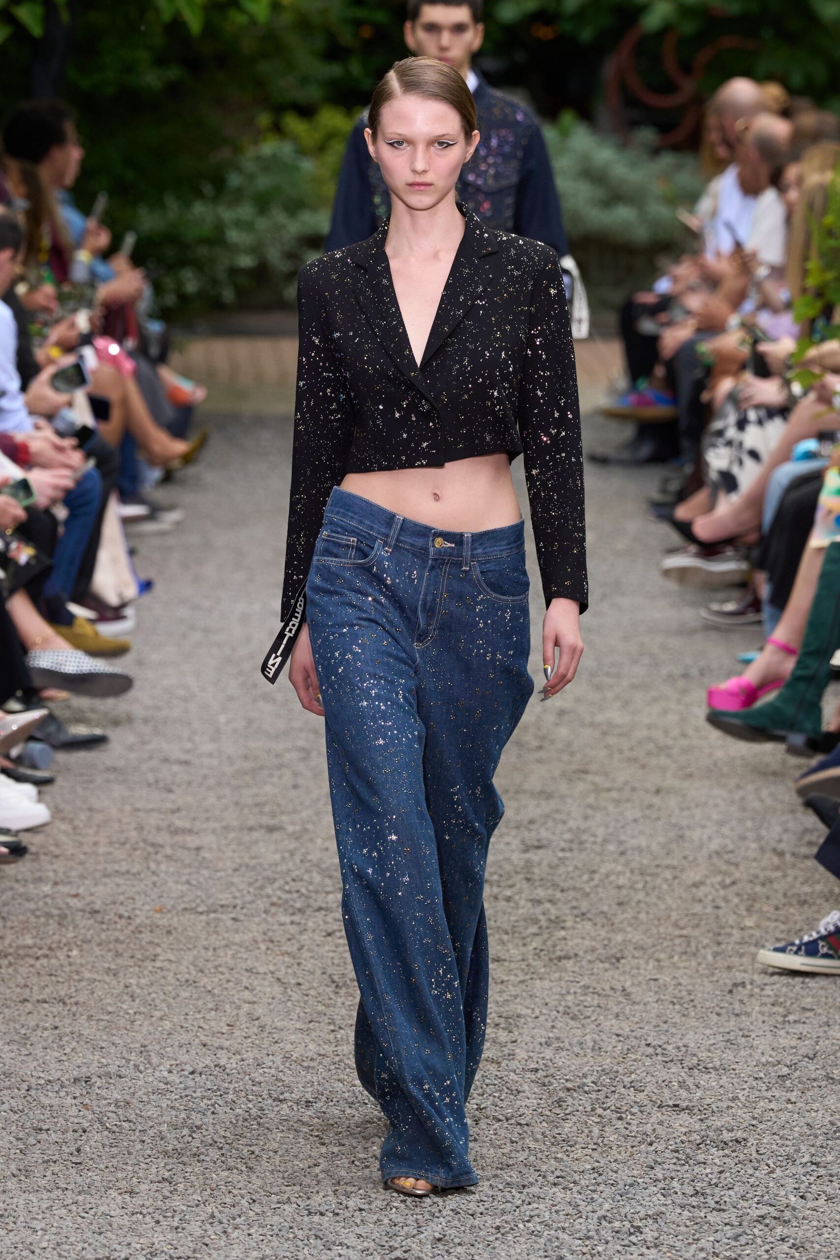 black embellished jacket with blue jeans