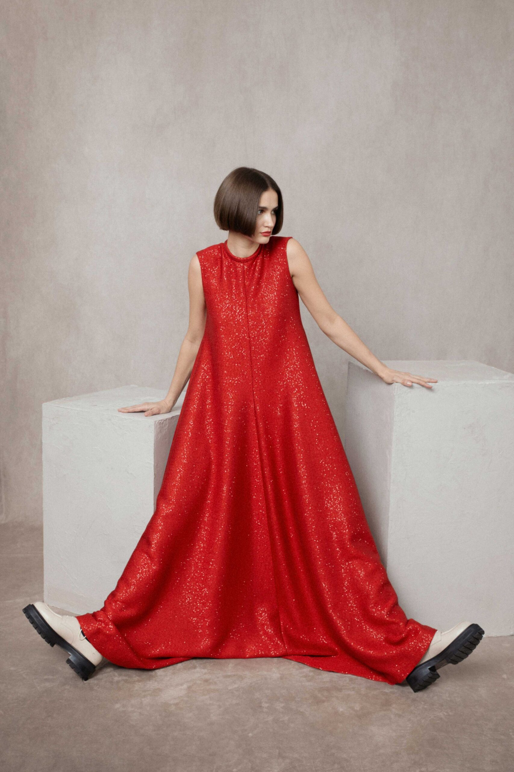 red silk sleeveless high-neck relaxed flowing shiny gown