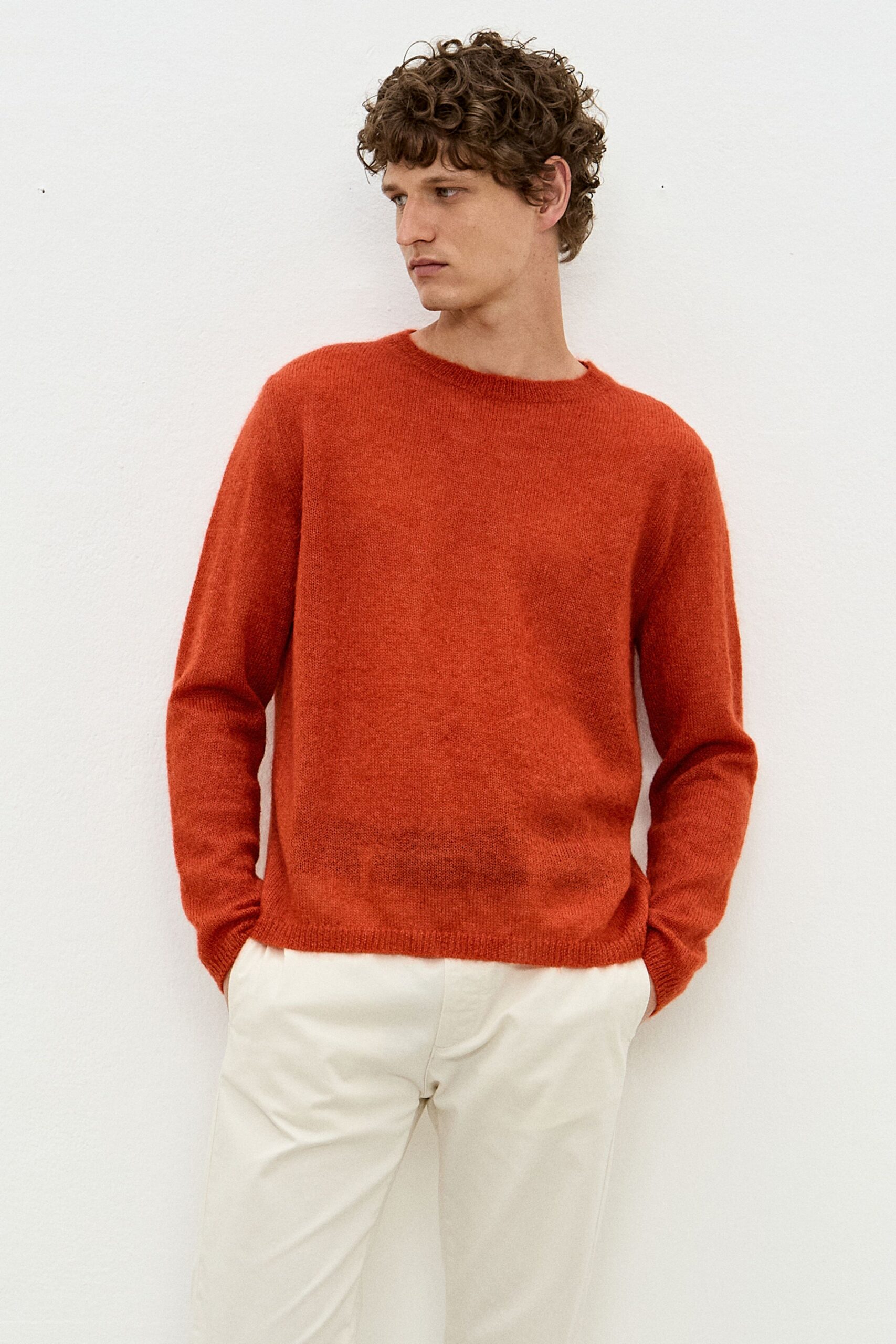 orange wool sweater and beige pants