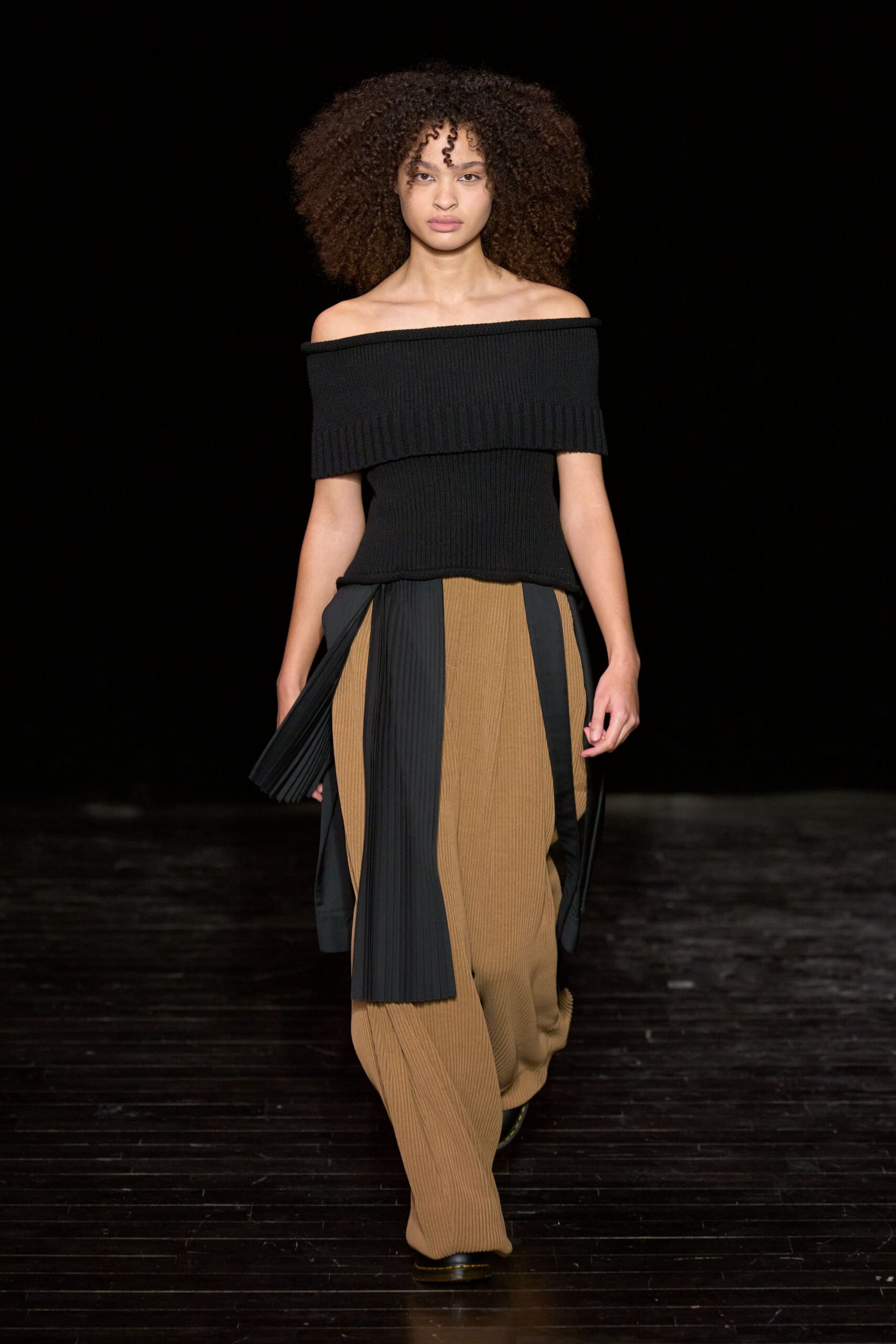 black off-shoulder top and beige pleated pants