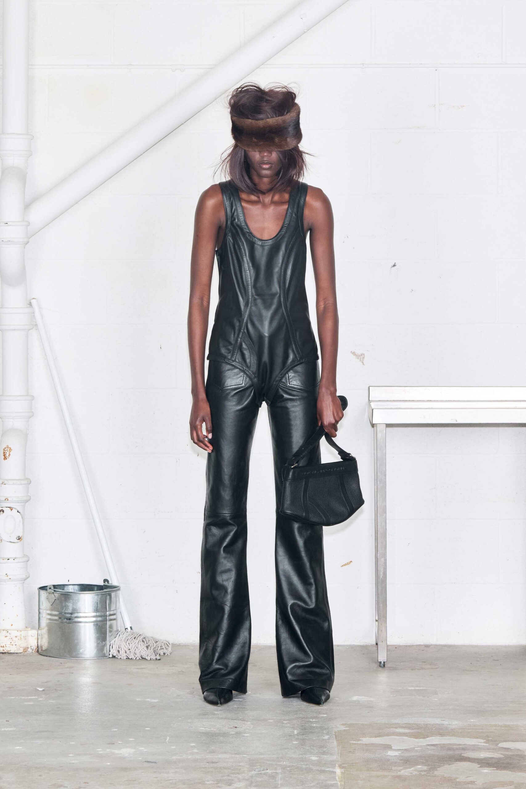 black leather sleeveless v-neck fitted flared catsuit
