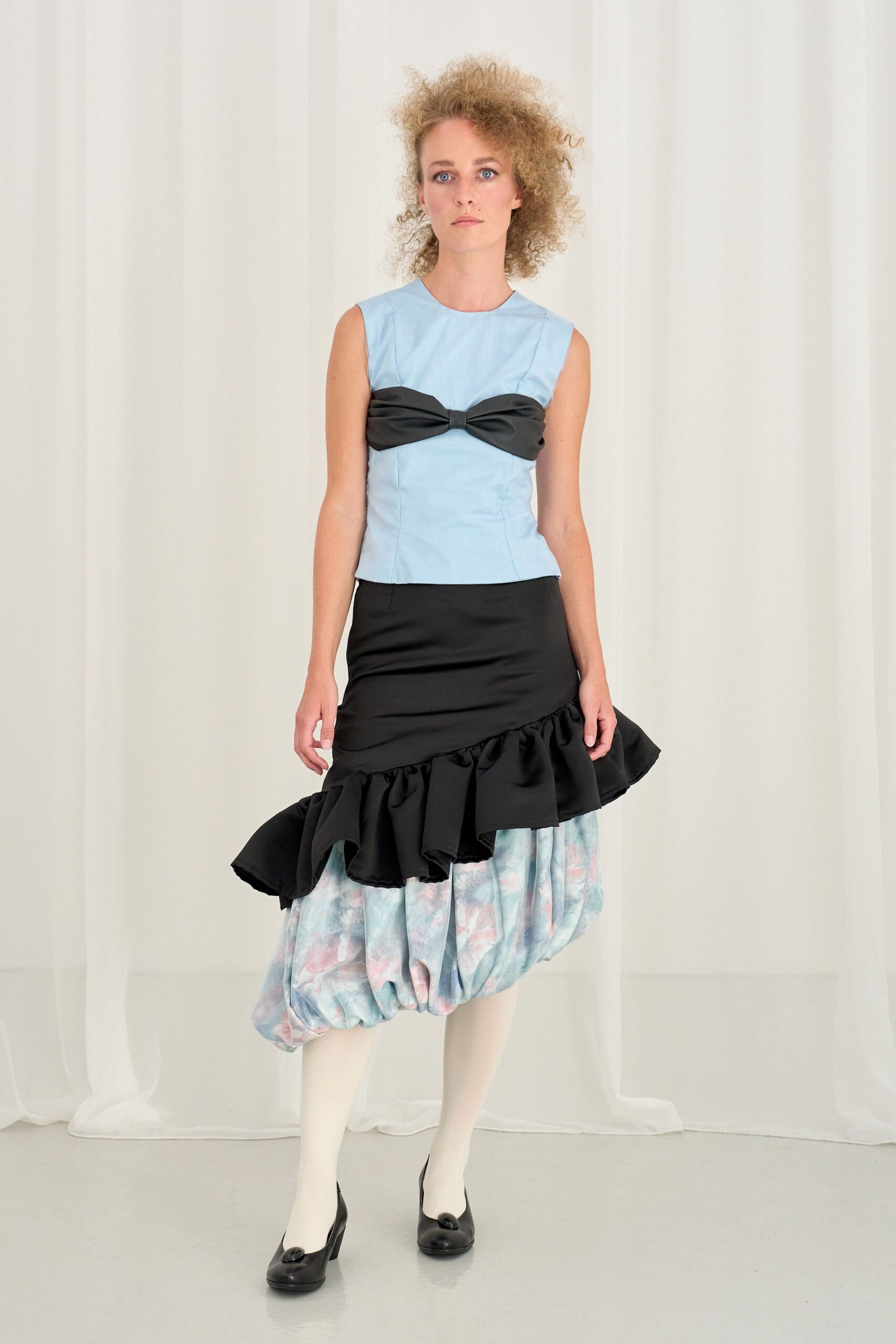 blue fitted top with black skirt
