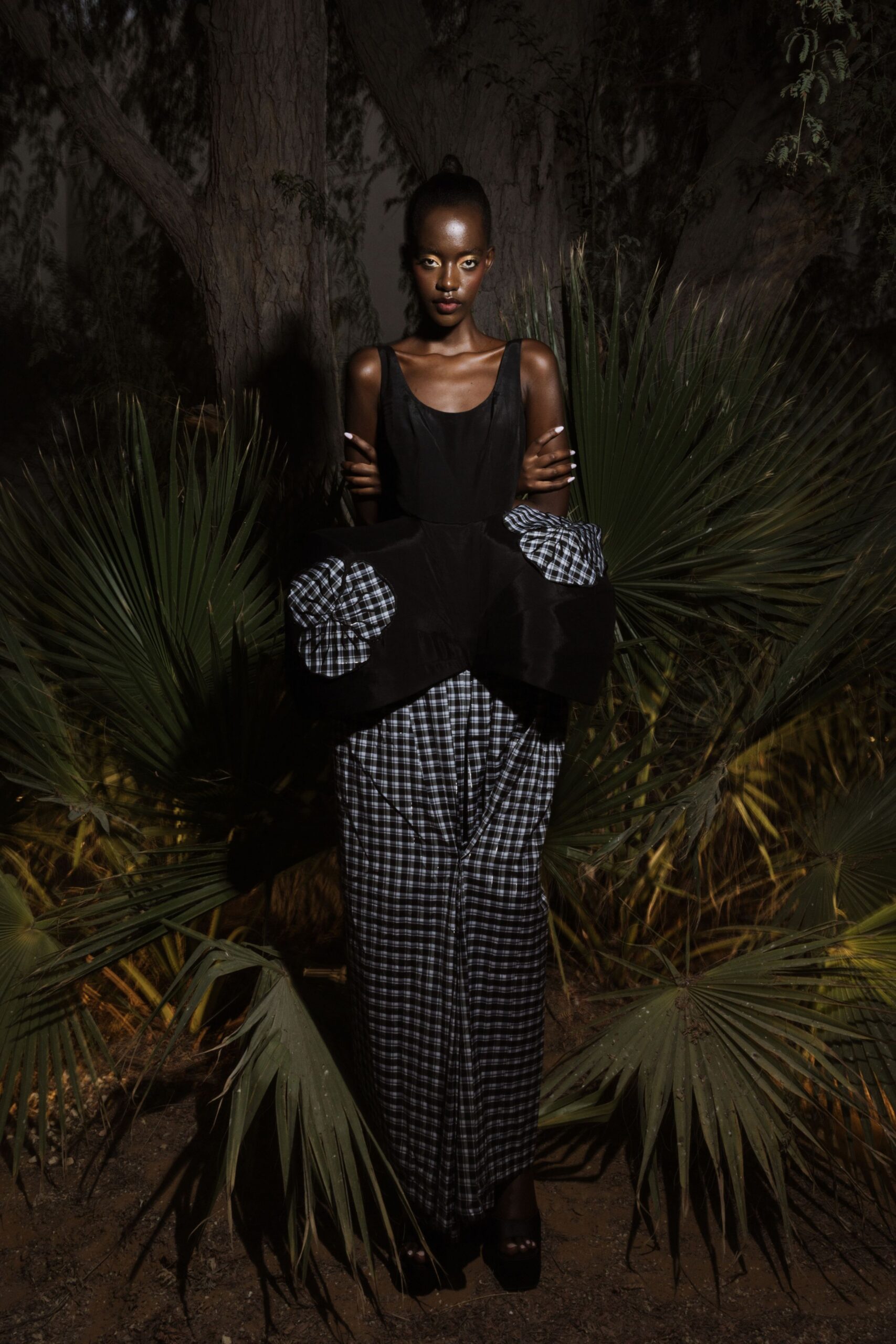 black silk sleeveless top with checked pants