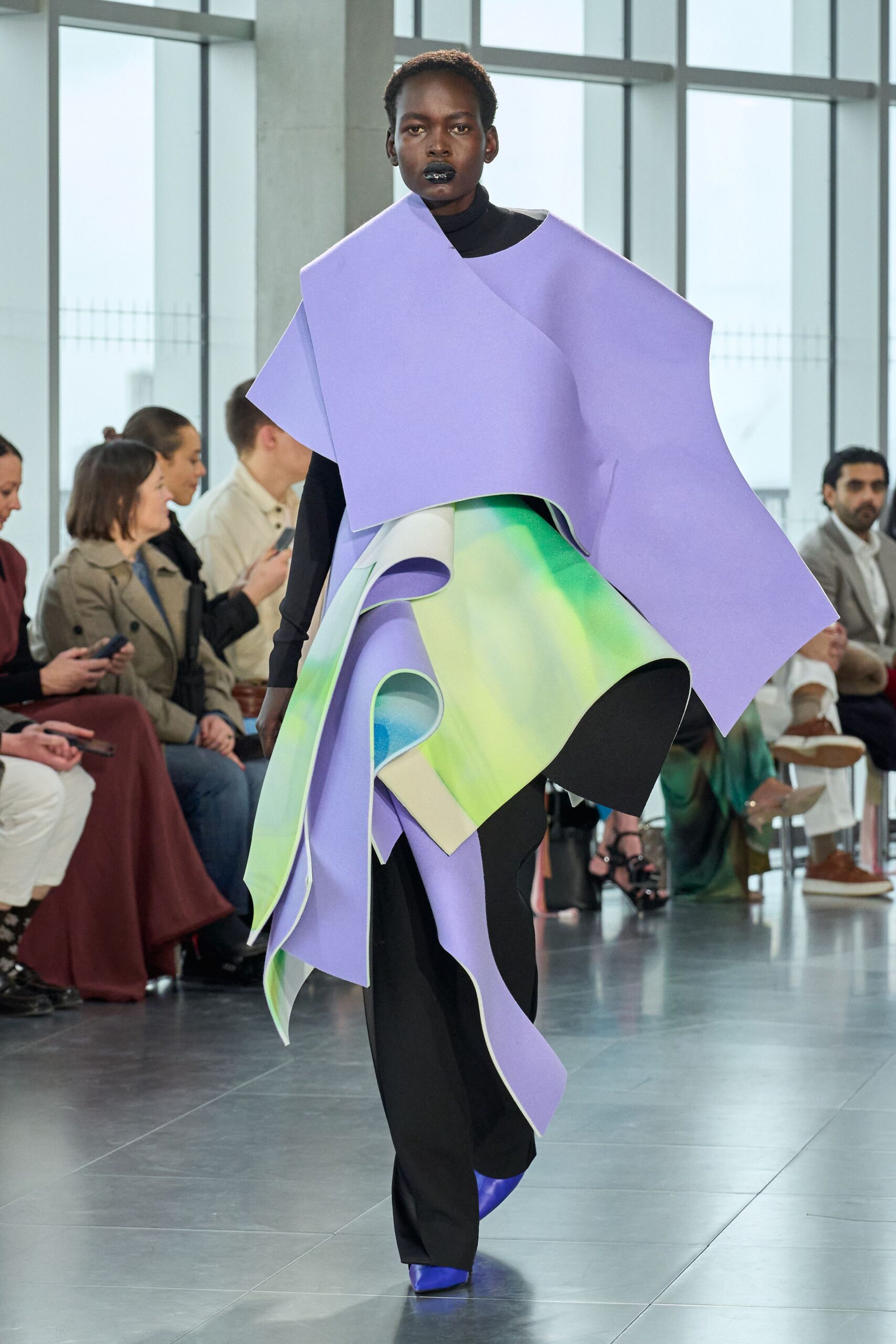 purple draped top with black pants