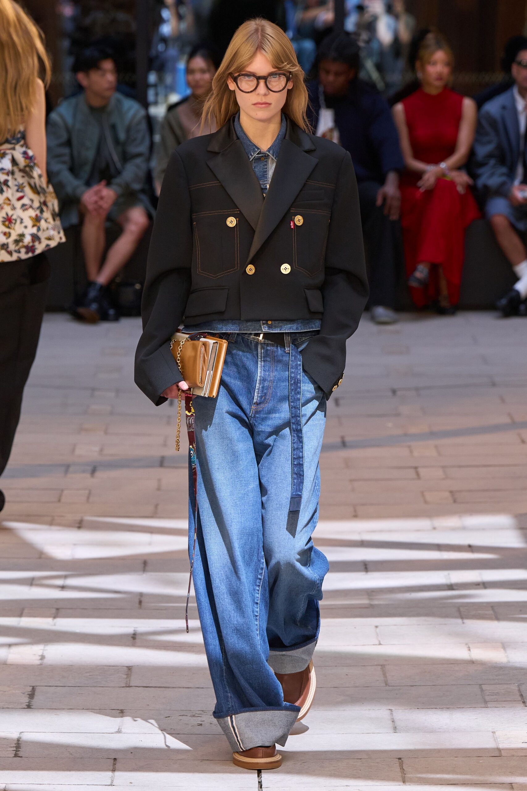 black jacket with denim shirt and relaxed pants