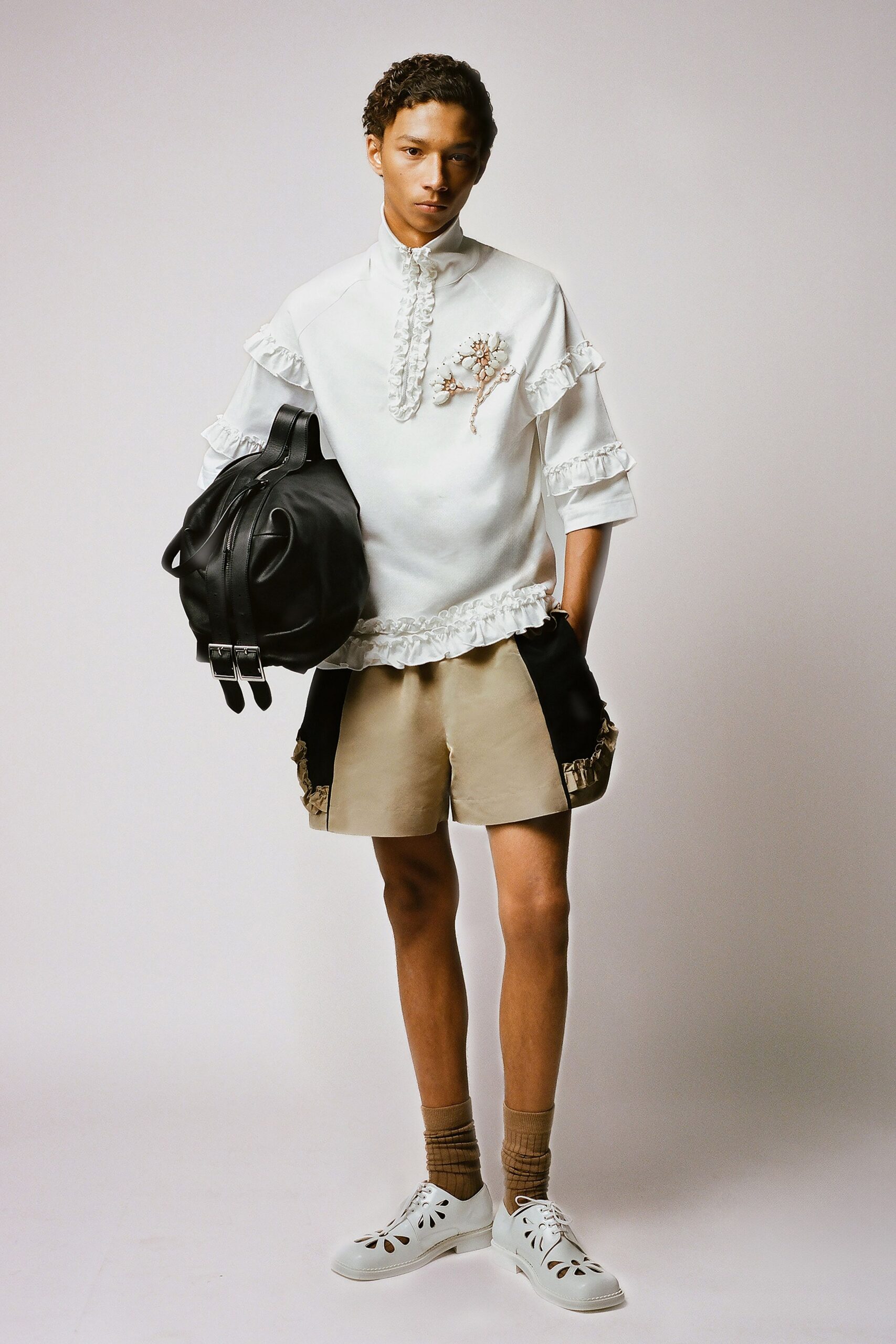white relaxed shirt with beige shorts