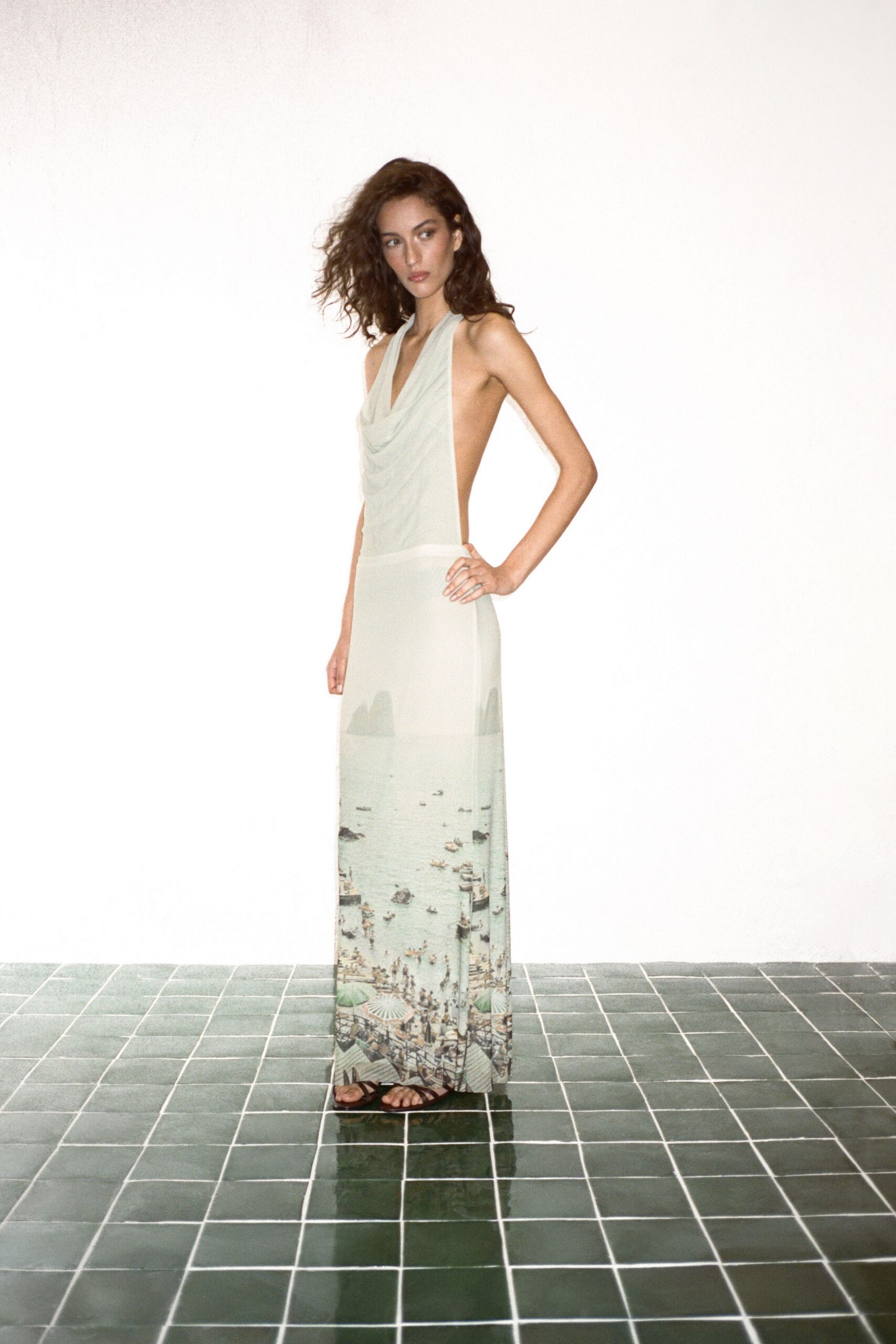 white silk sleeveless low-cut fitted draped printed gown