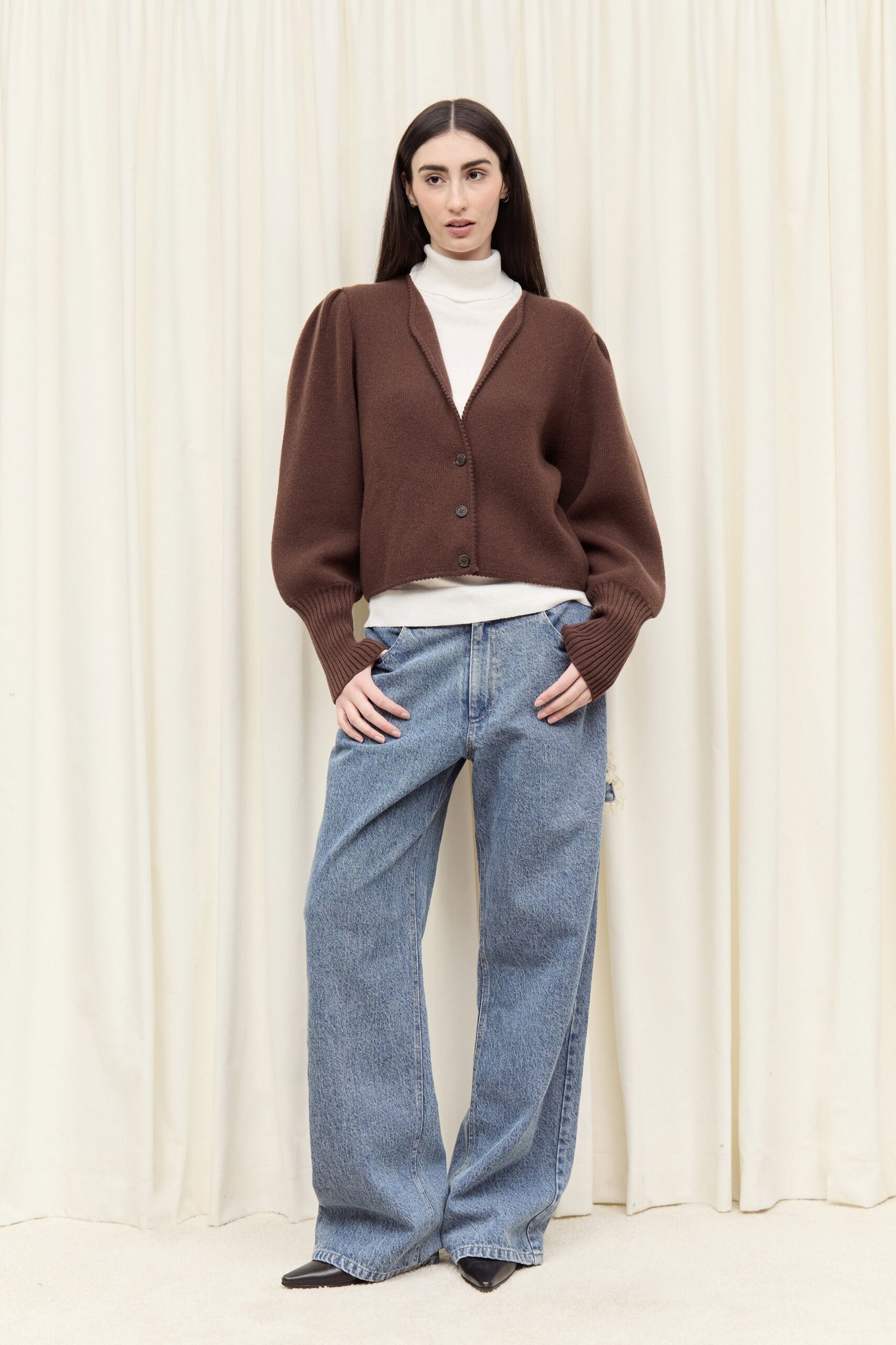 brown cardigan white turtleneck blue jeans black heels