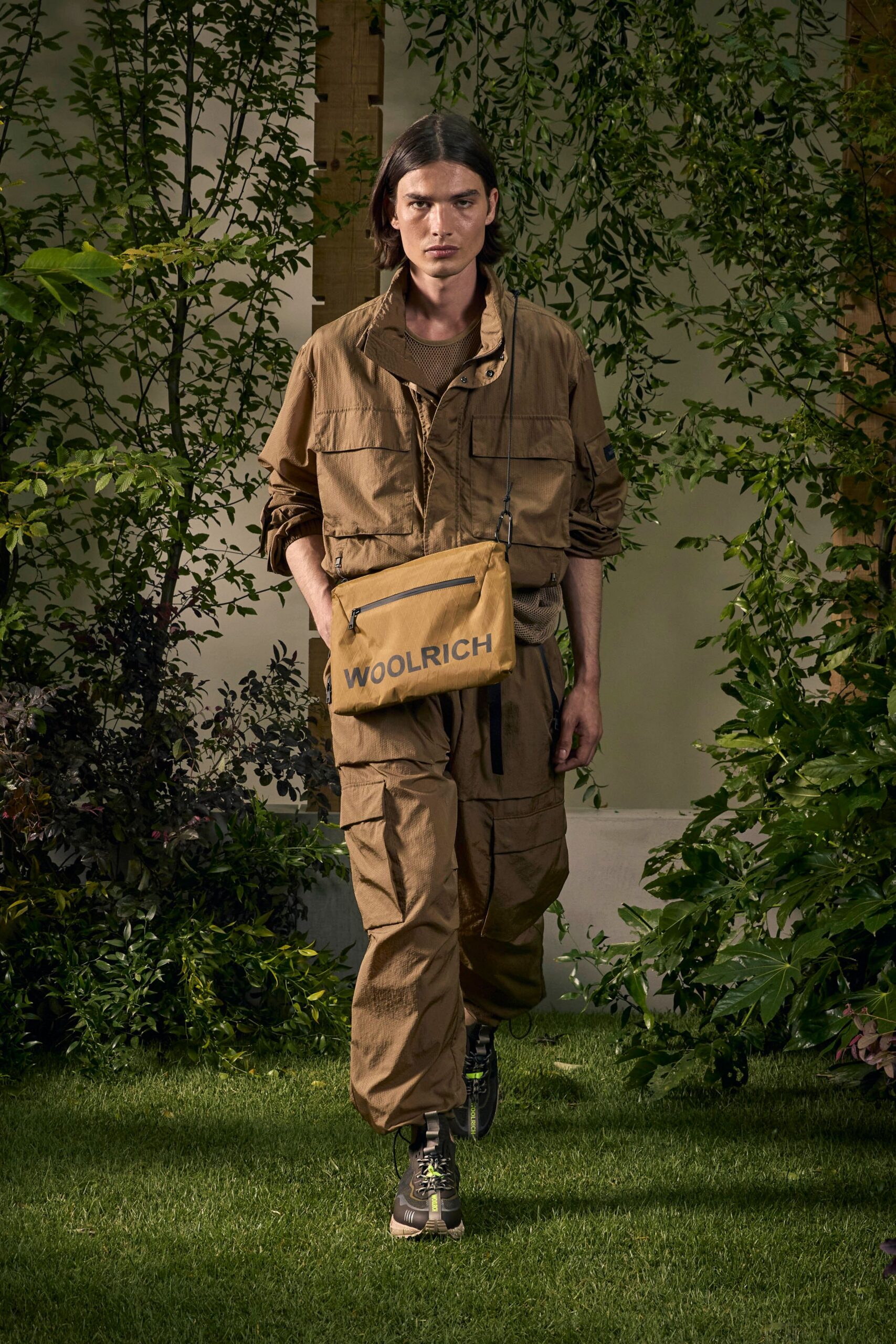 brown relaxed jumpsuit with yellow bag