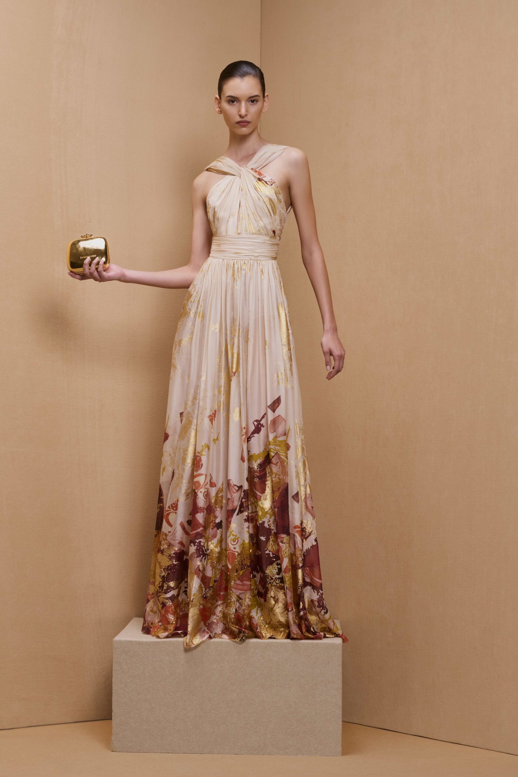pink floral halter gown with gold clutch