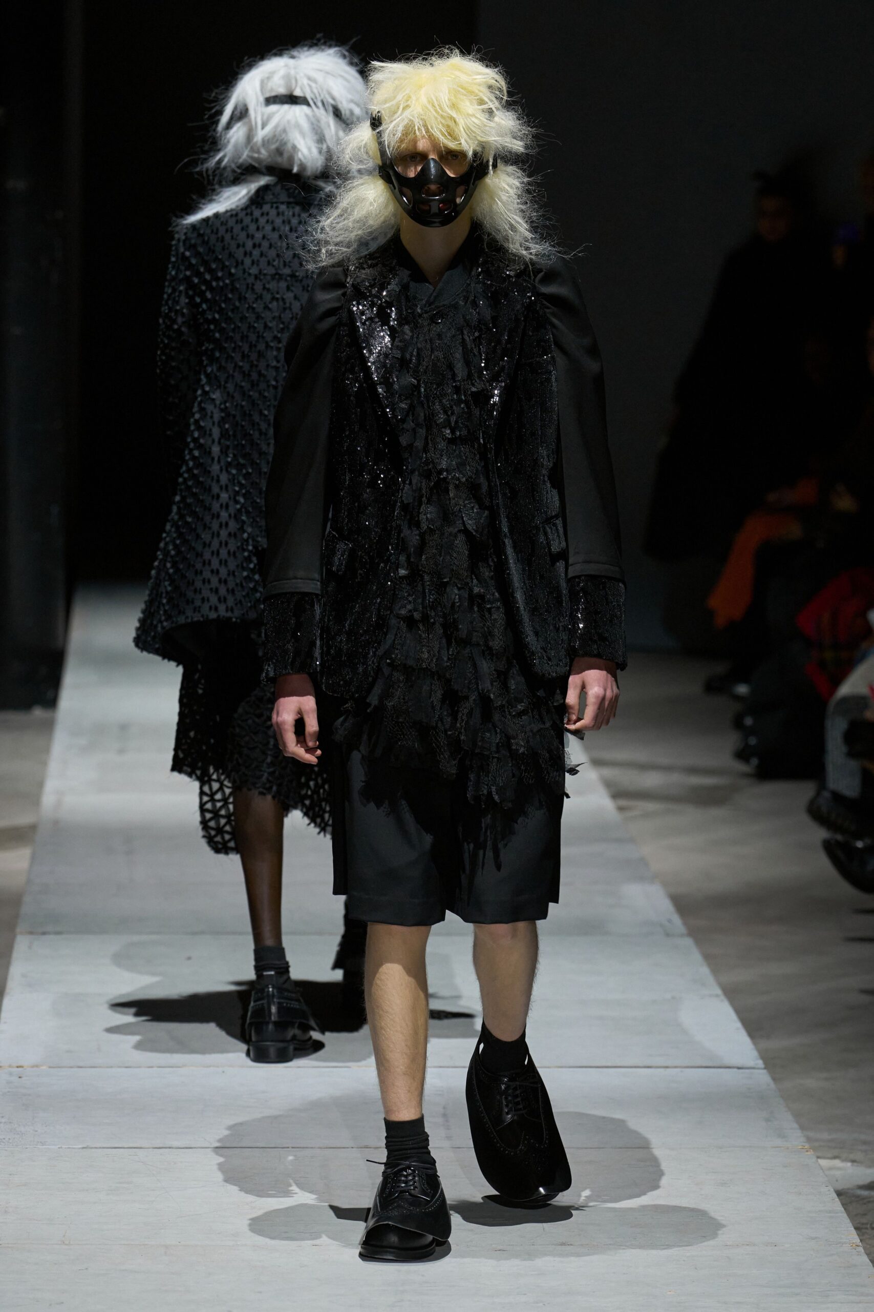 black relaxed coat with fringed detail