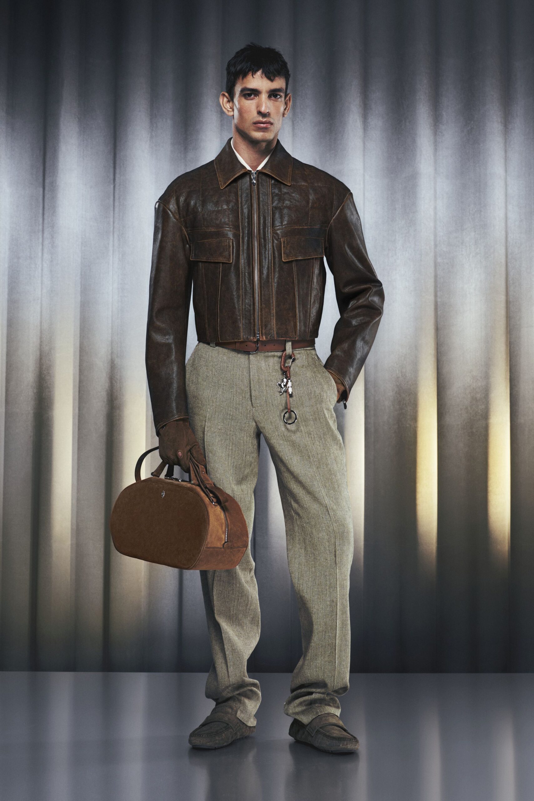 brown leather jacket with gray pants