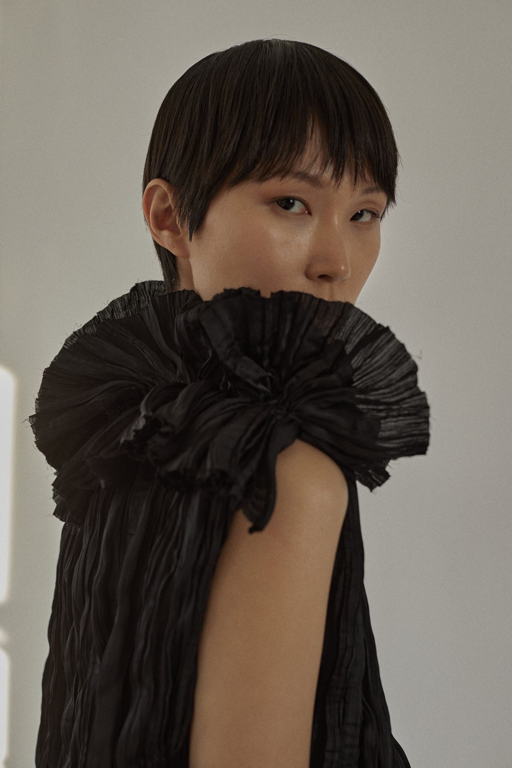 black pleated sleeveless dress