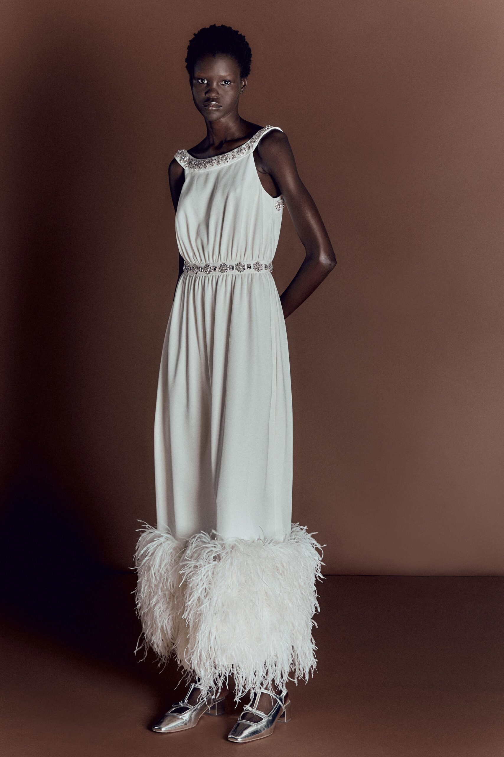 white silk sleeveless dress with feathers