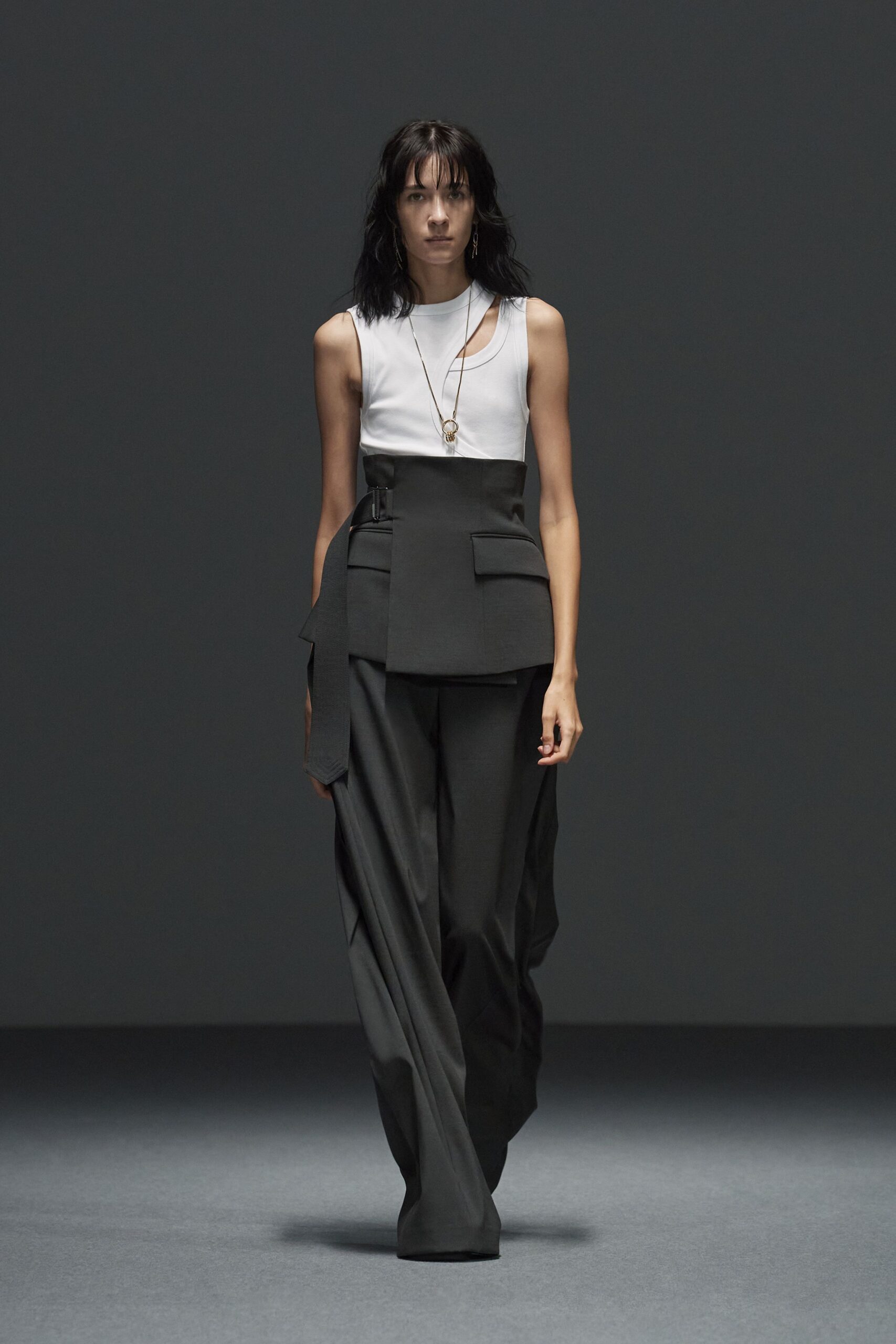 white sleeveless top and black pants